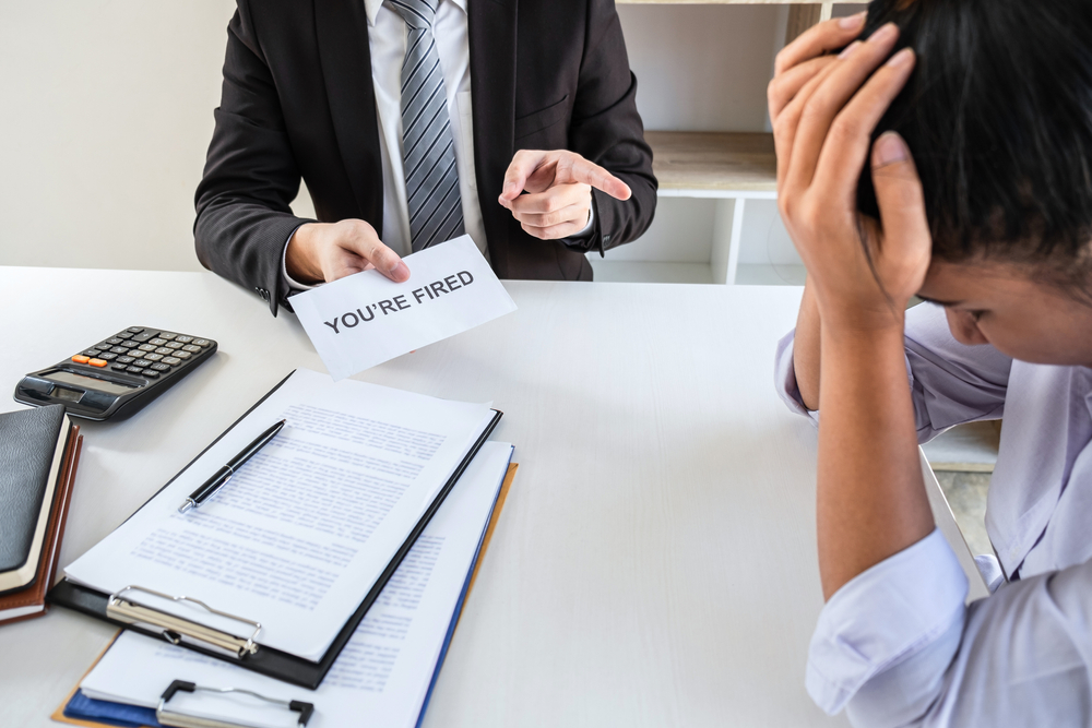 A male boss firing his employee