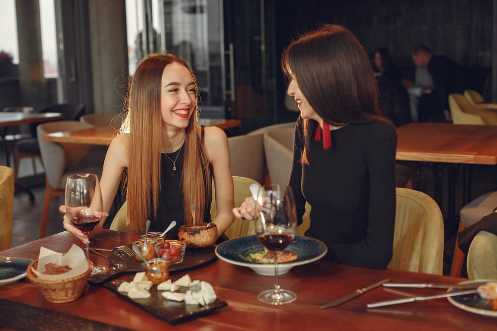 Two women sharing lunch at a fancy restaurant.