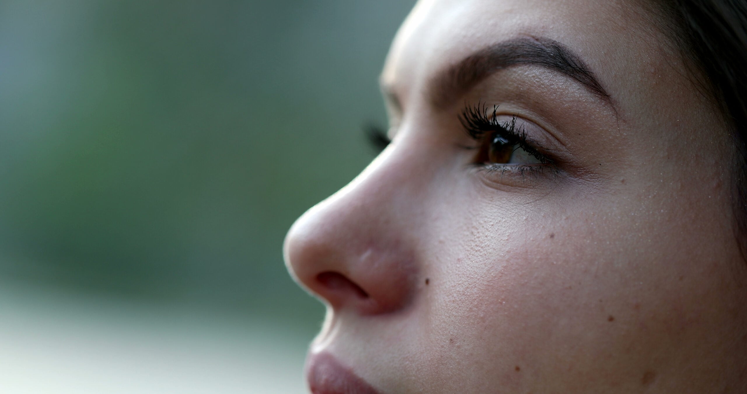 Woman's face with a zen and confident expression.