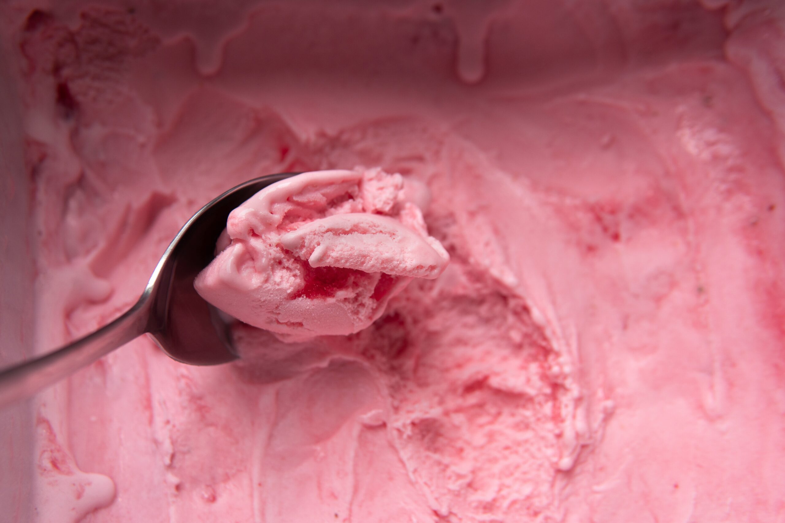 A bucket of strawberry ice cream.