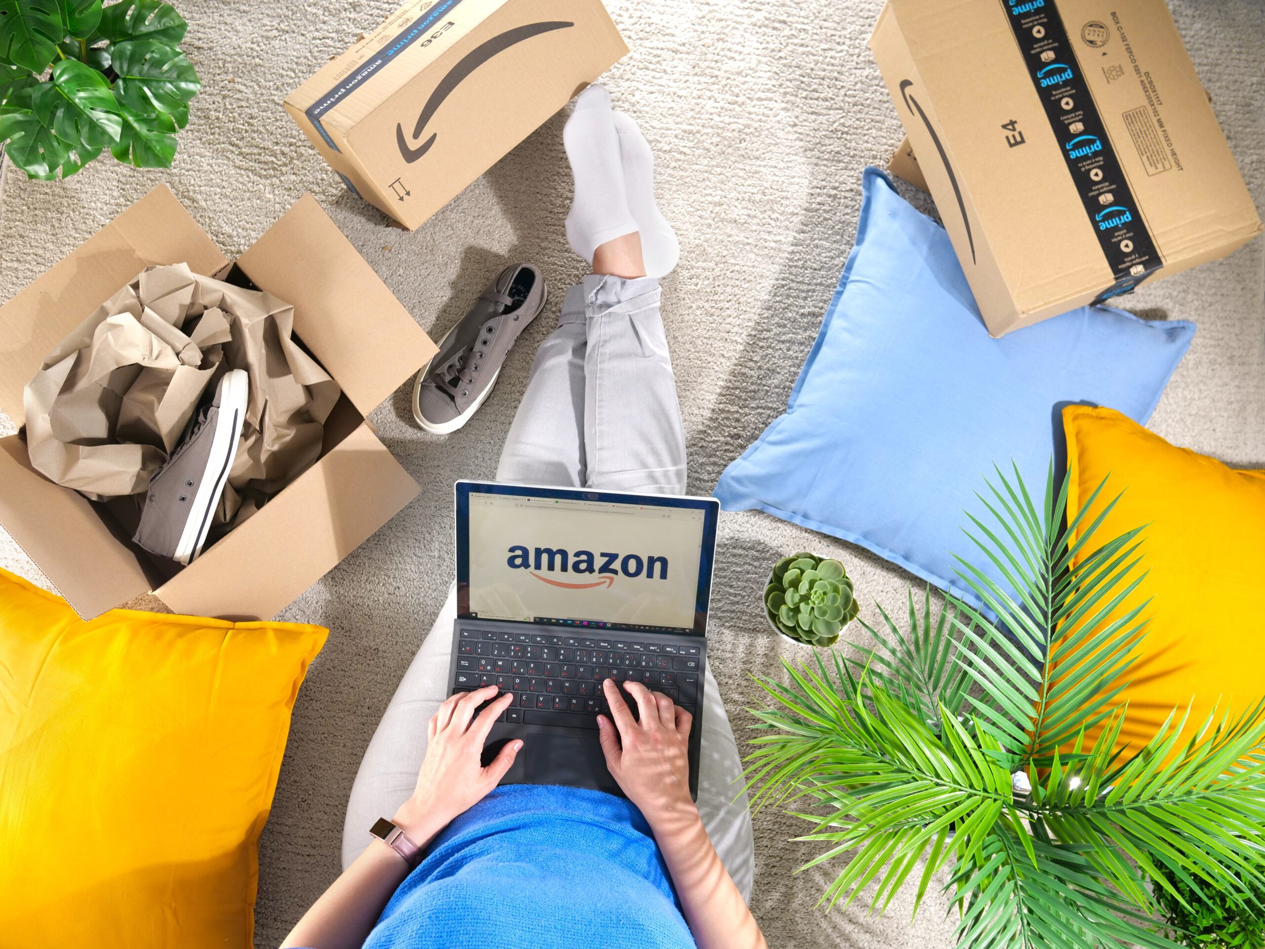 A man reviewing his Amazon deliveries while on his computer.