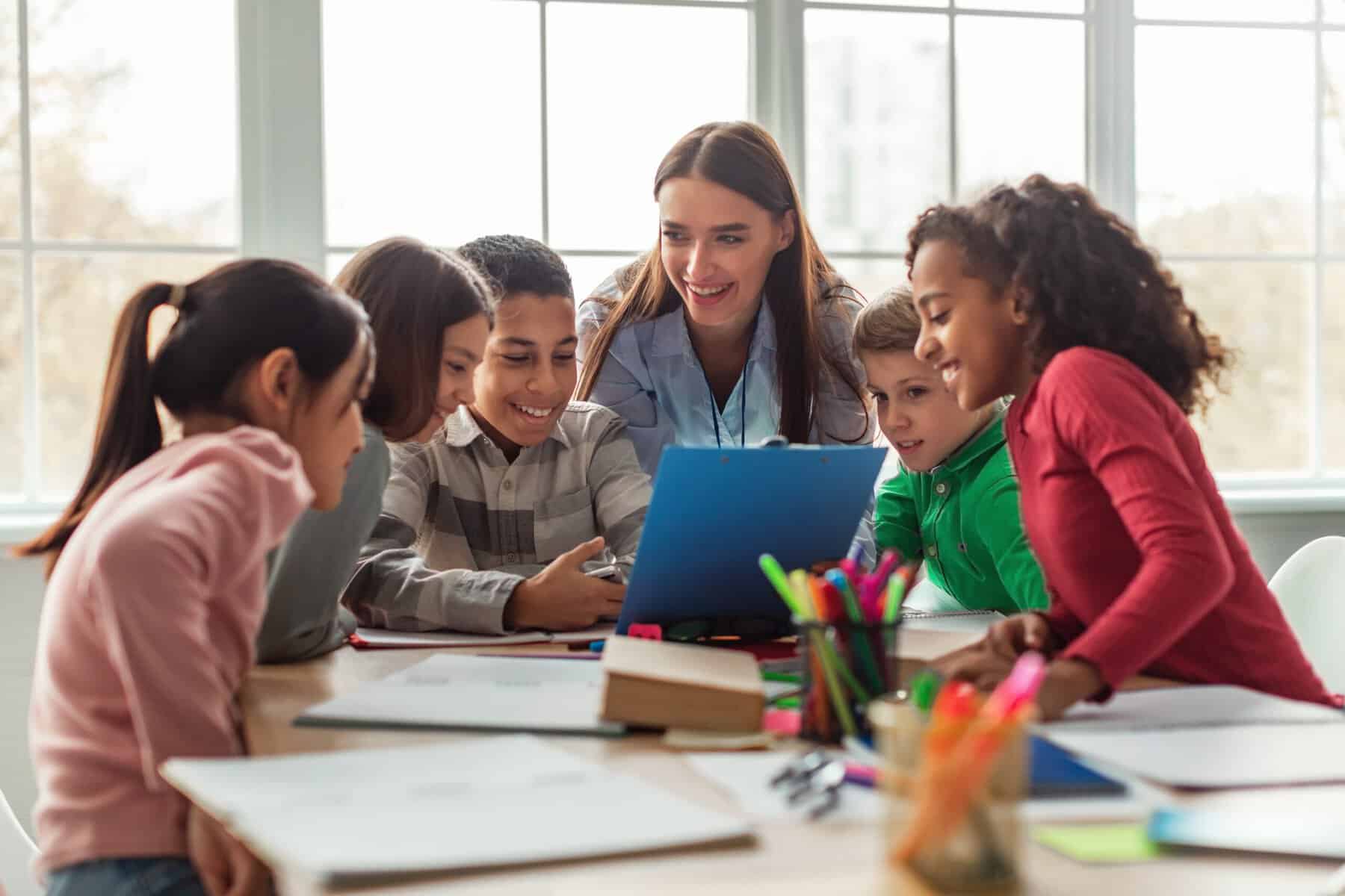A school teacher in class with her young students.