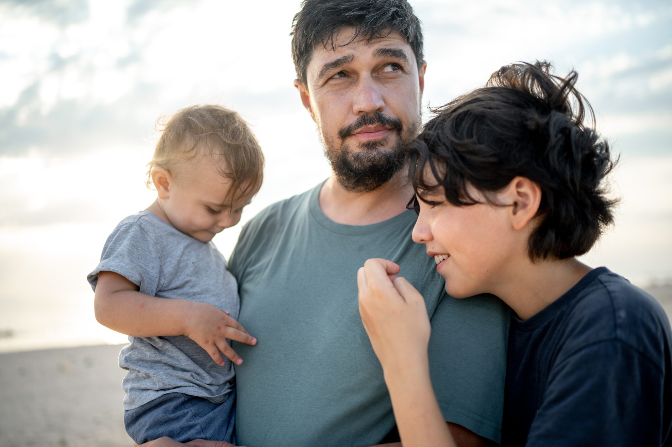 A father shows love and care while spending time with his sons.