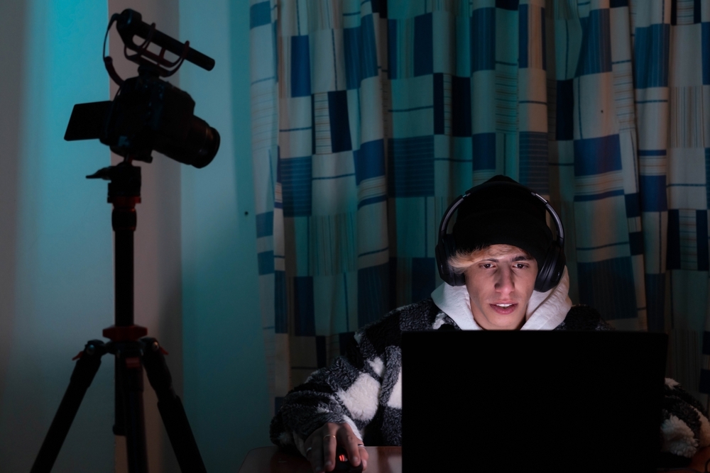 Young man in the dark playing video games online.