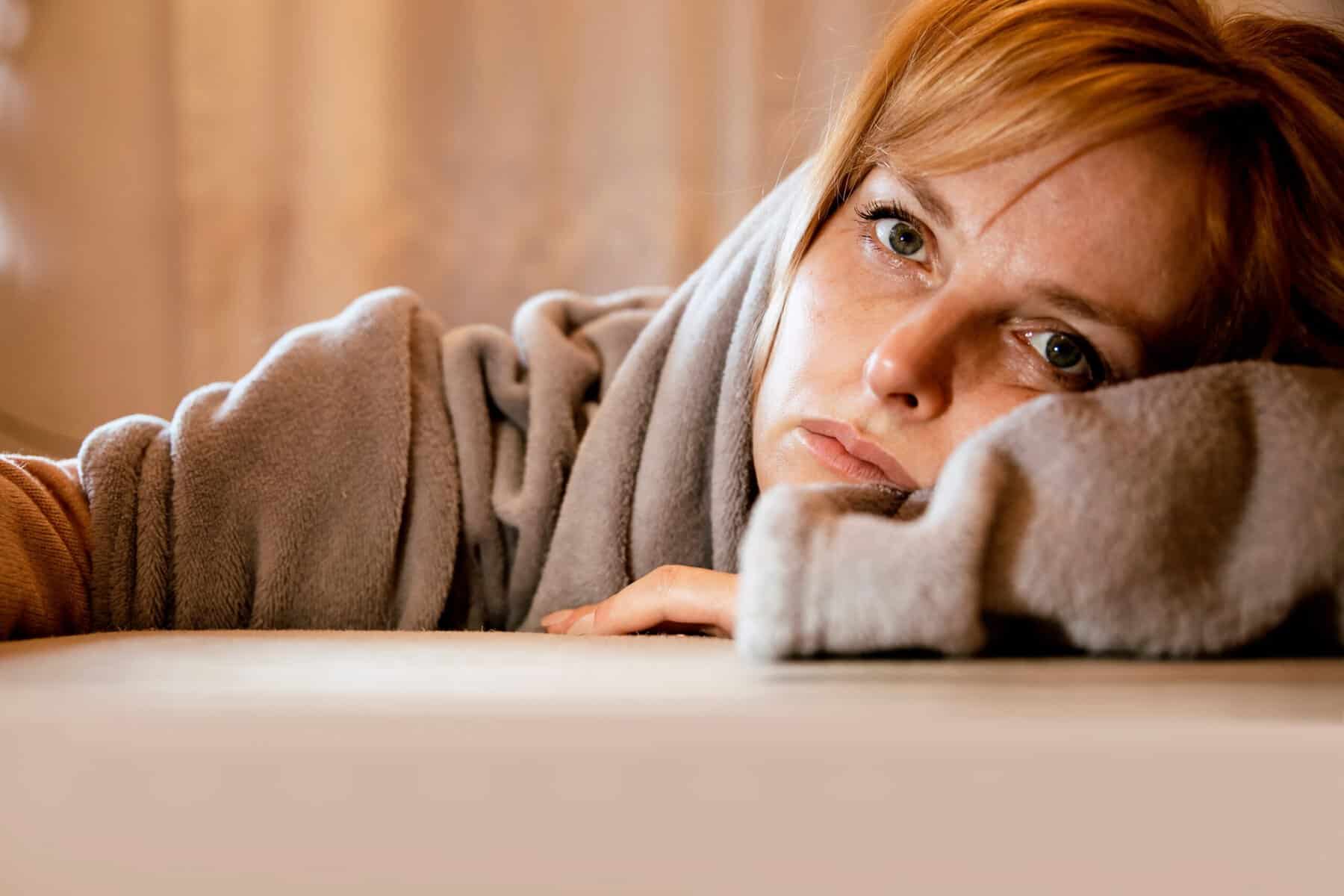 A woman feeling very lonely with her head resting on a table.