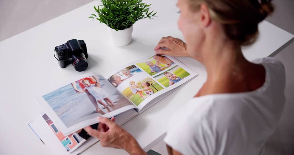 A woman looking at pictures in a photo album