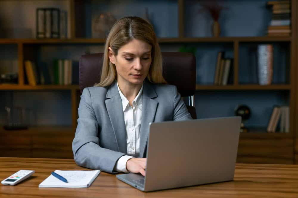 A busy confident business woman working with her laptop