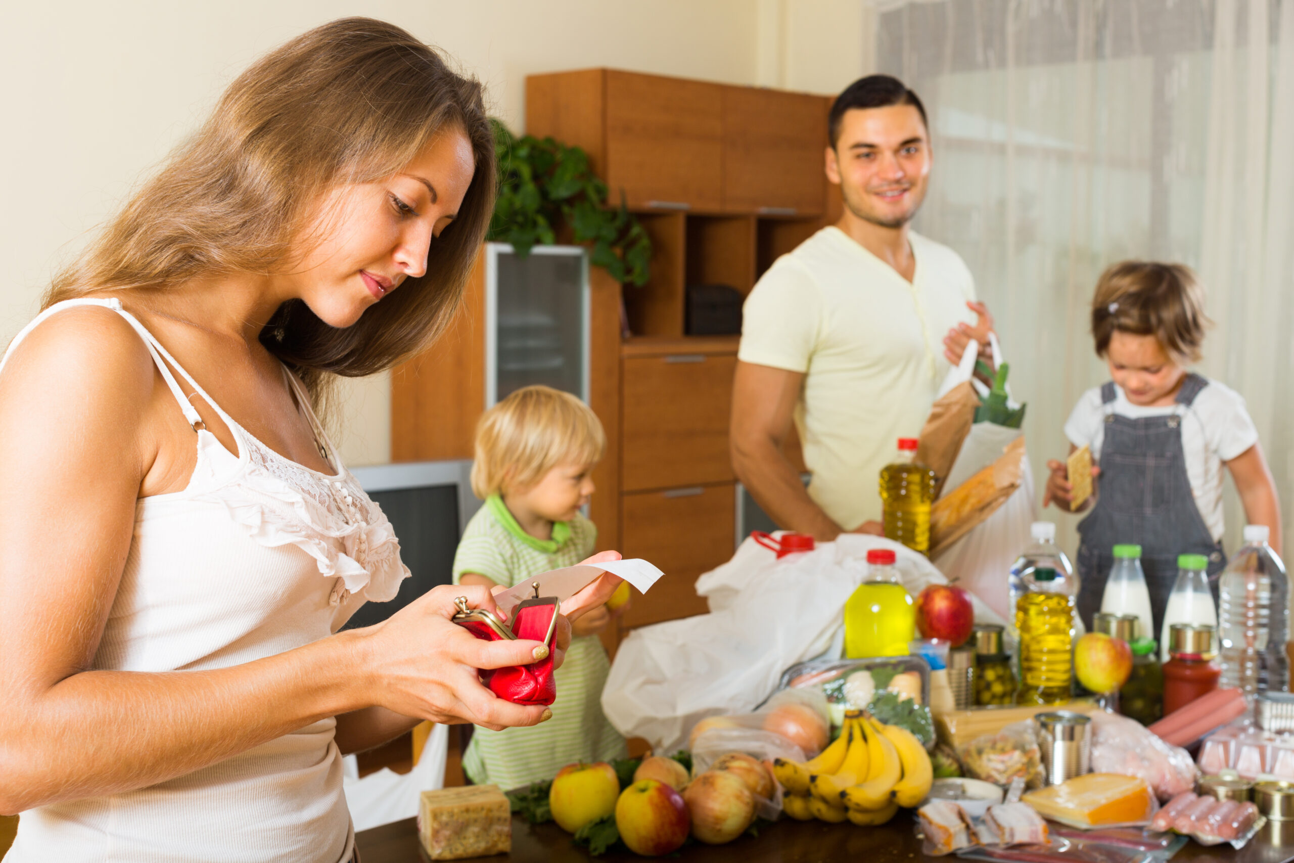 Low income family checking the receipt of their recent grocery bill.