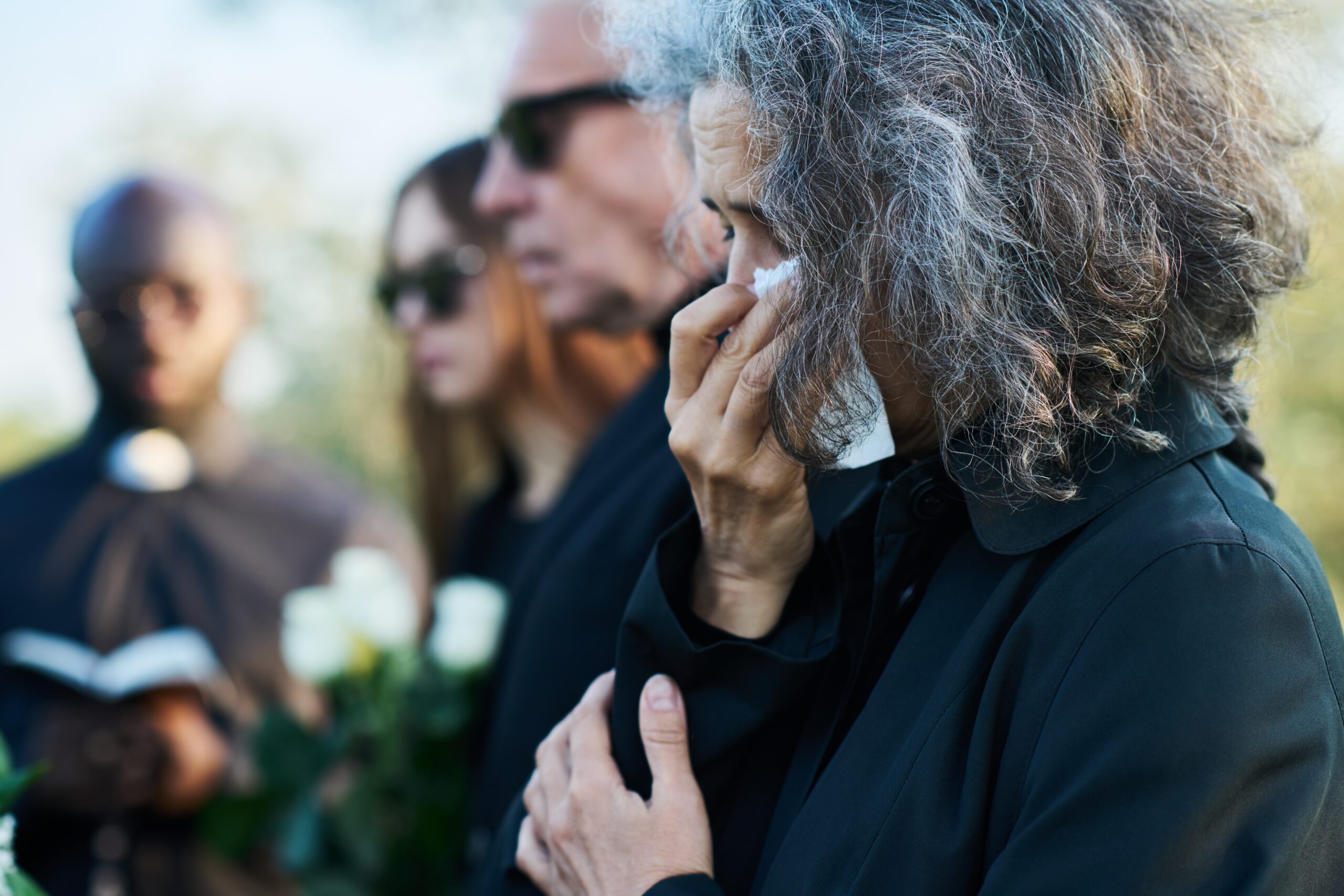 A woman grieving the loss of her parent.