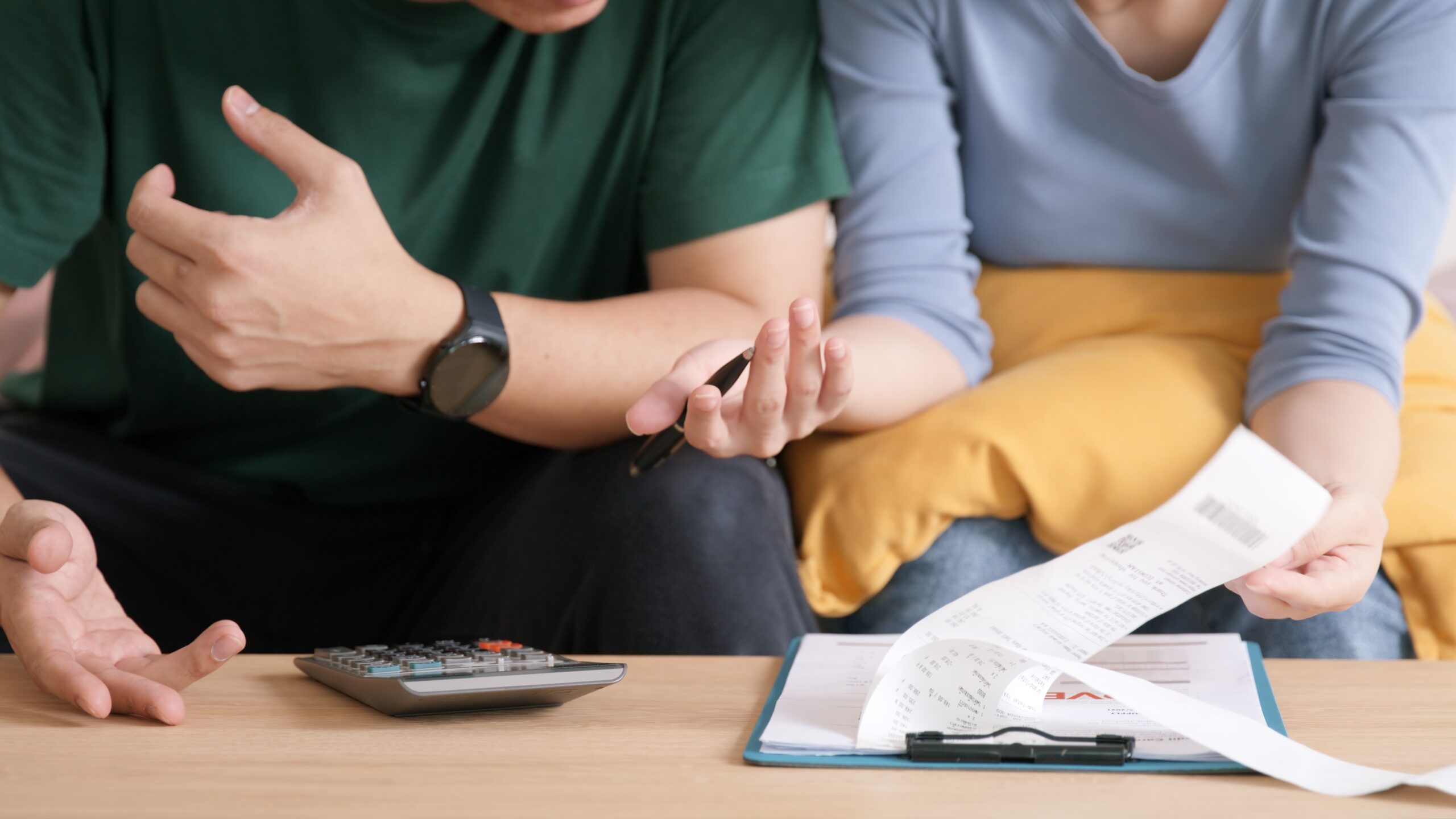 A low-income couple managing their monthly bills together.