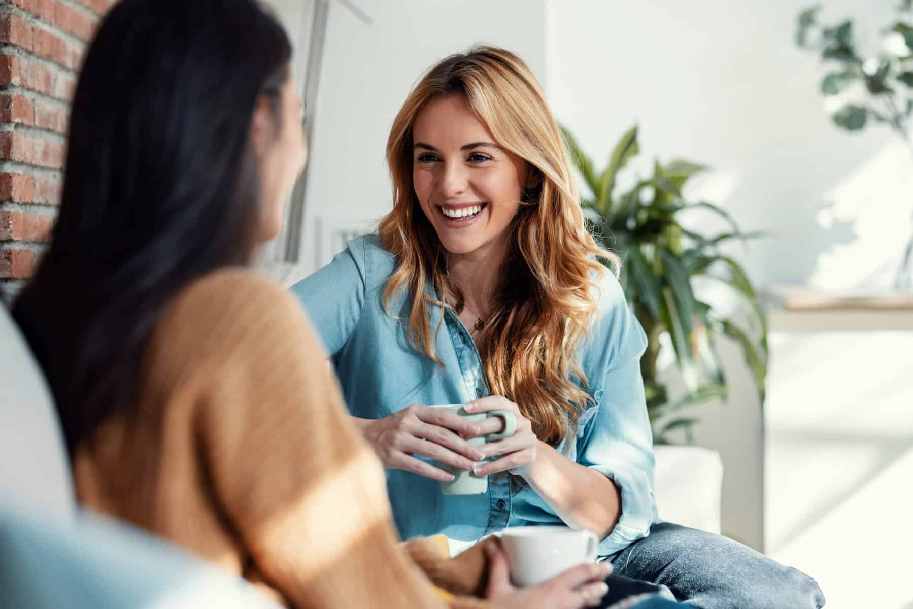 Magnetic woman having coffee with a friend.