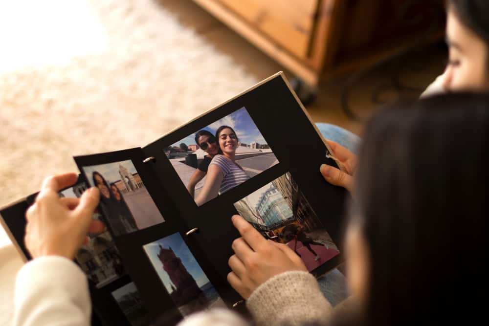 A young couple looking at pictures in a photo album