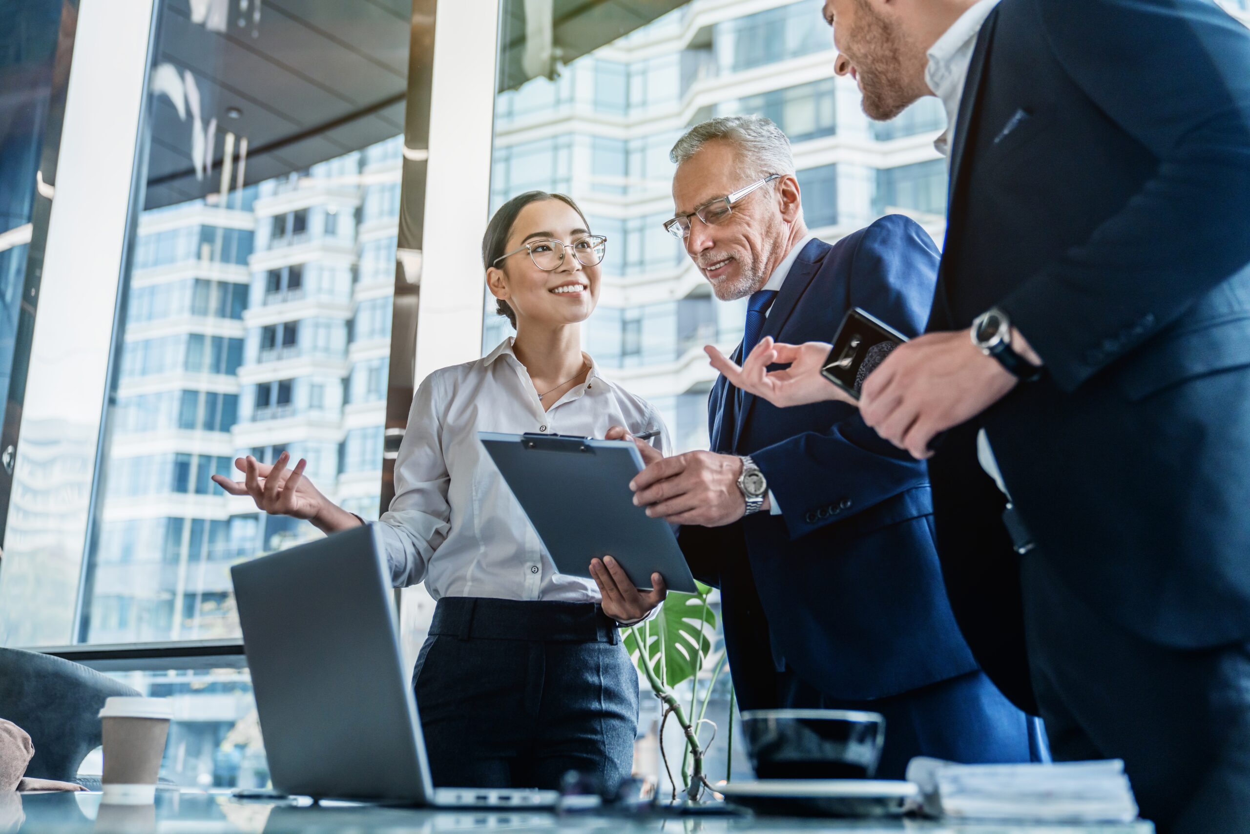A business woman is taking command in a work meeting with her colleagues.