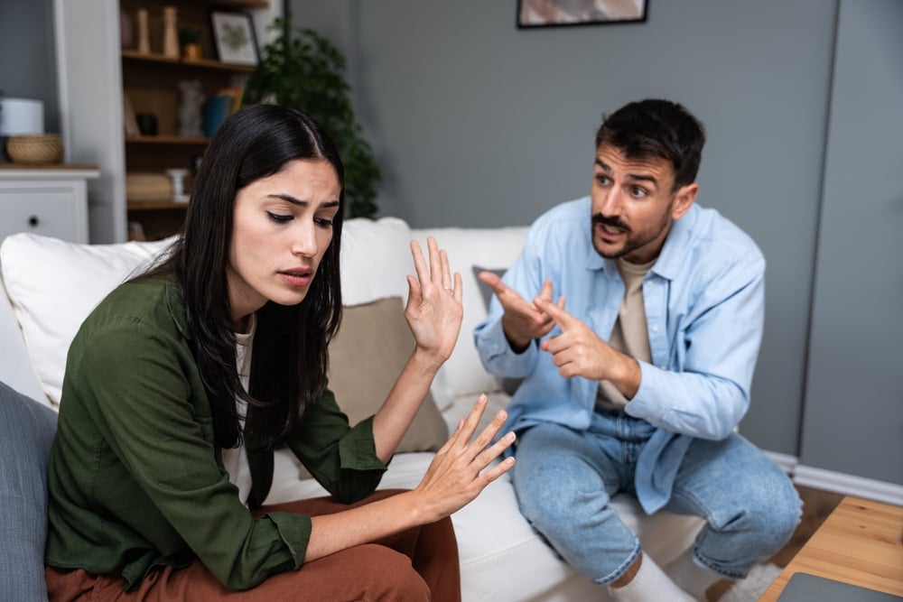 A young couple quarreling at home, the low quality husband is demanding for more time and attention