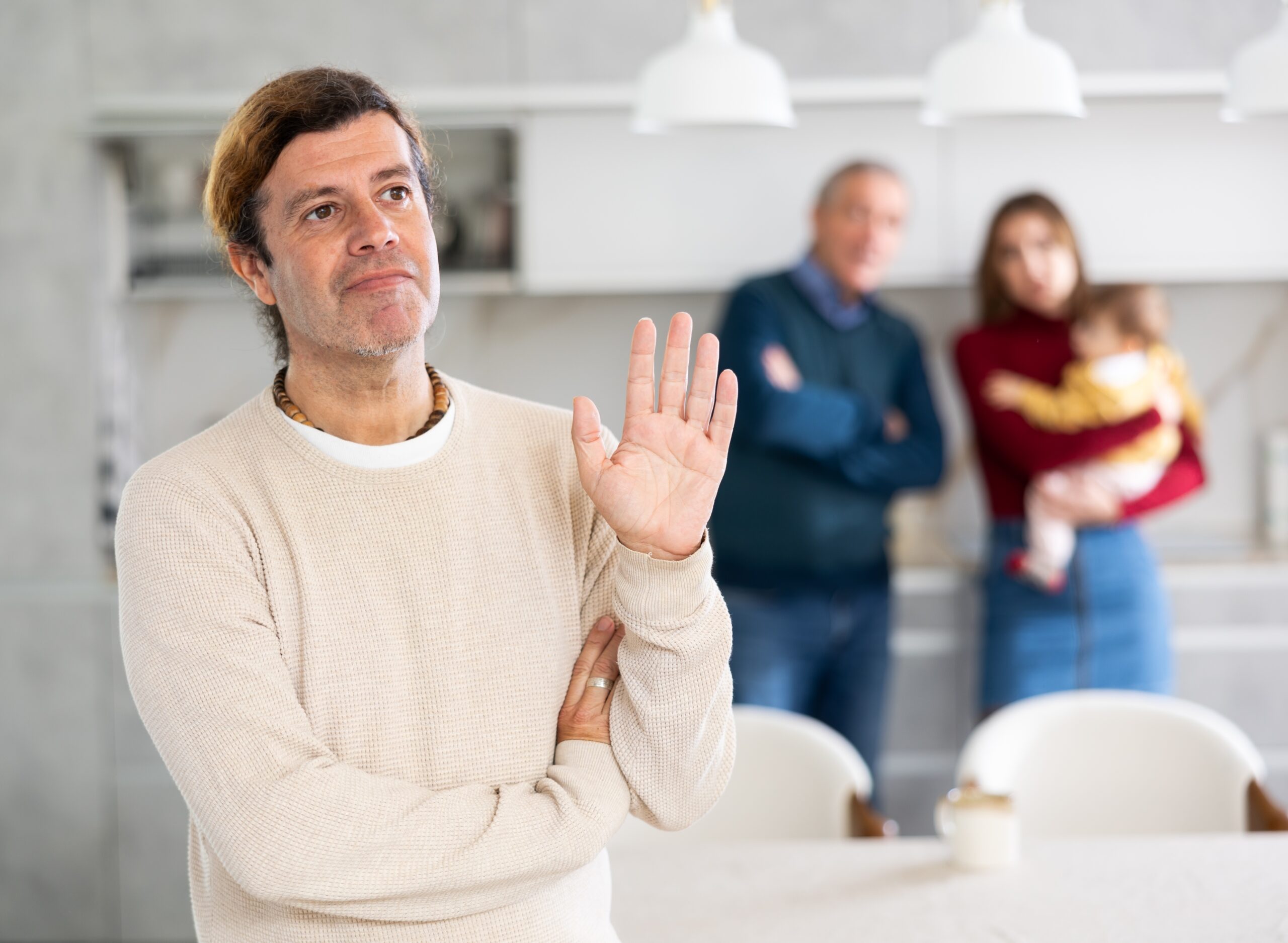 Man playing peacekeeper in a family argument.