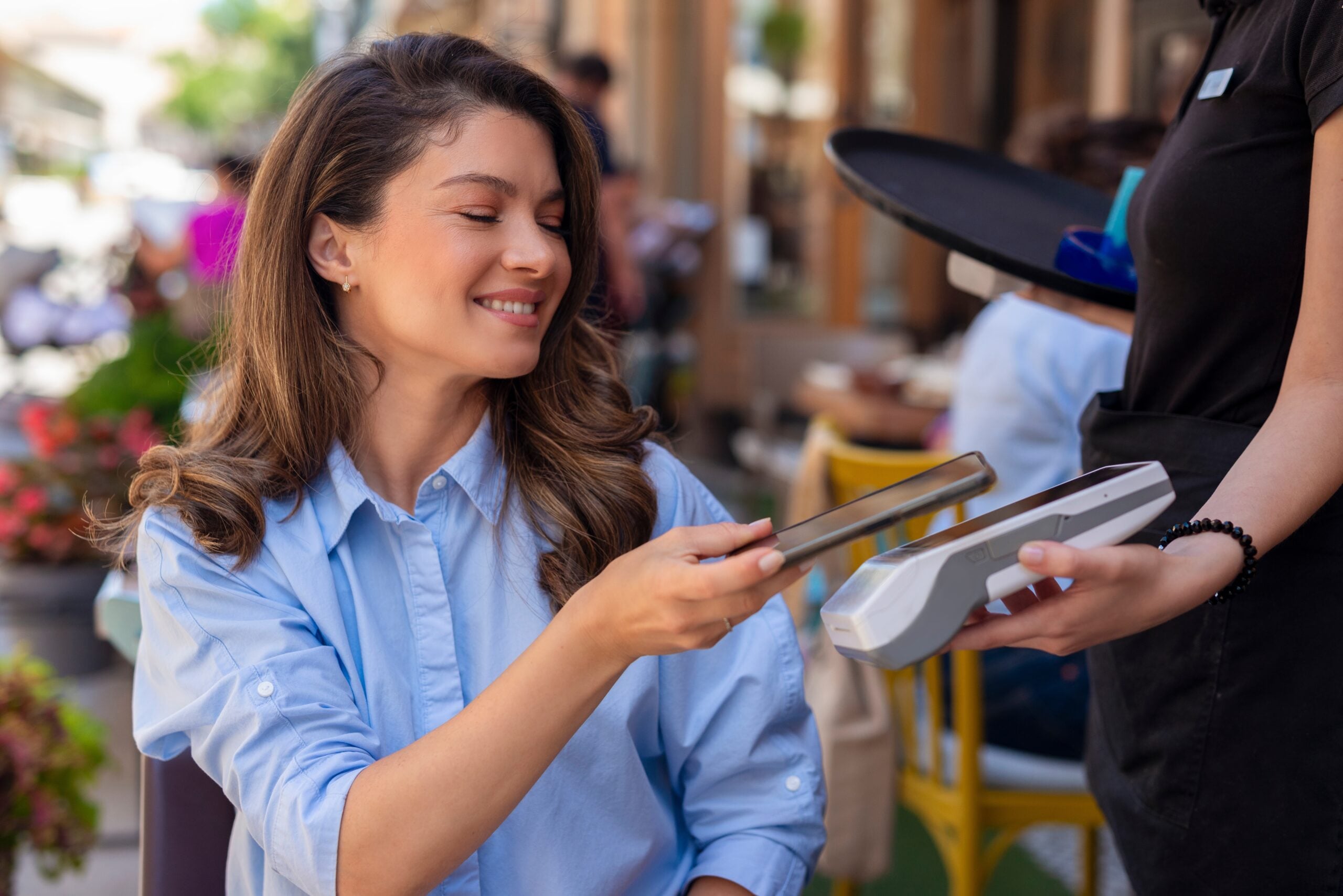 Young woman payinh the bill.