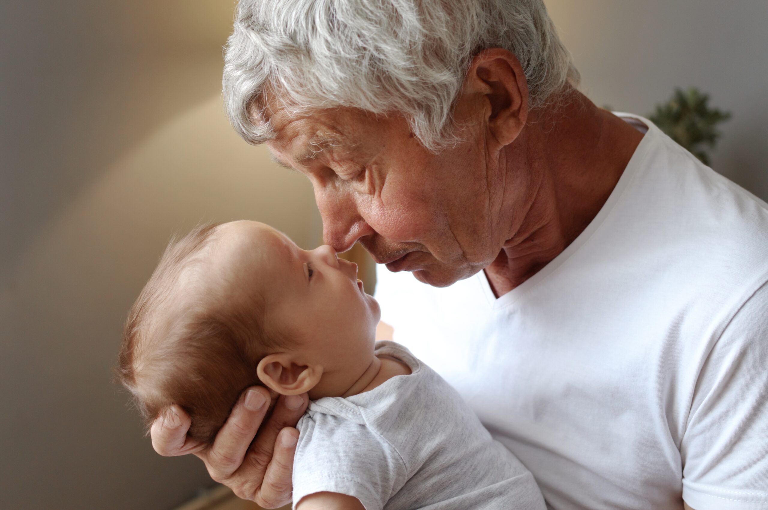 A loving grandfather dotes on his first grandchild.