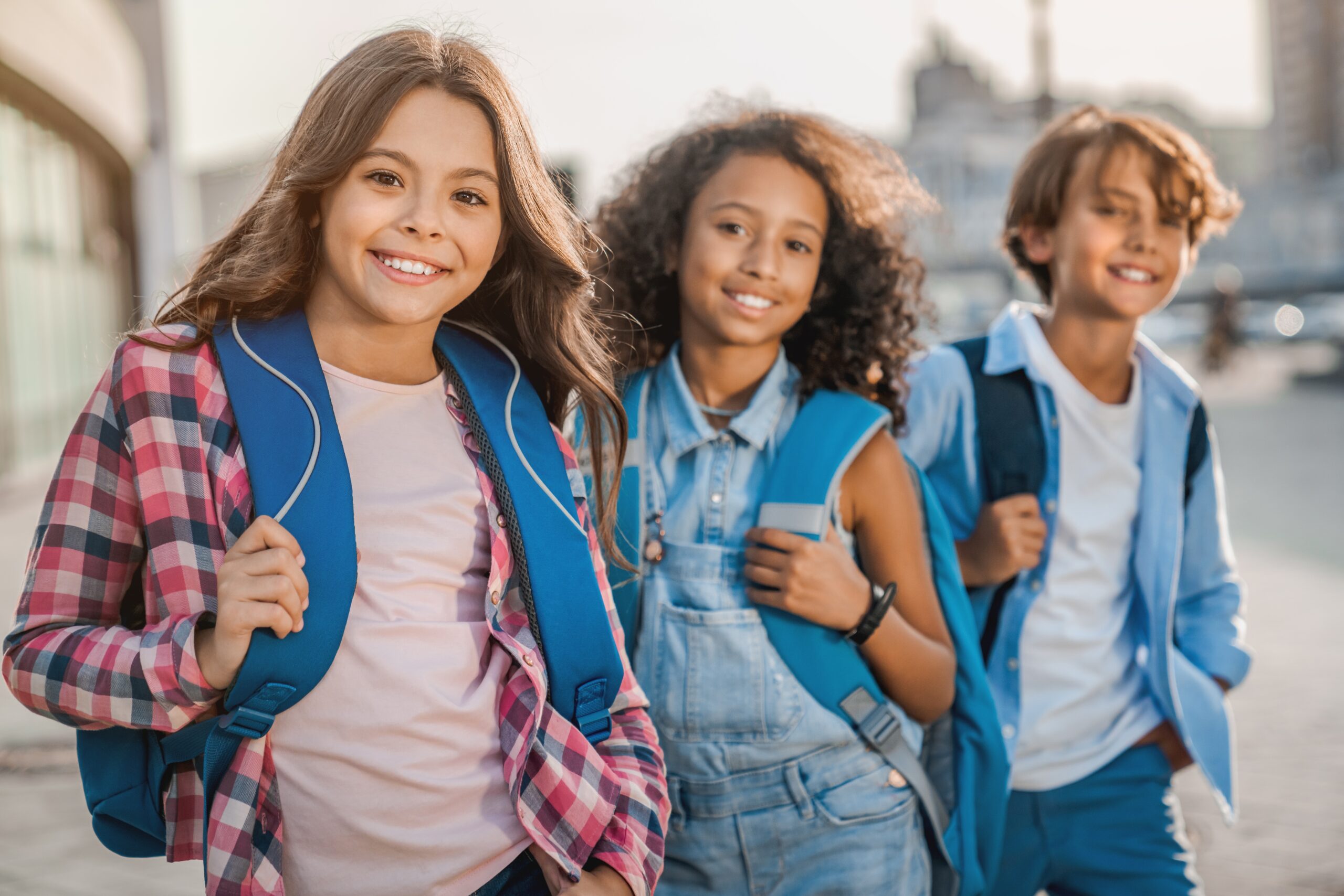 Schoolchildren with their backpacks outside of class.