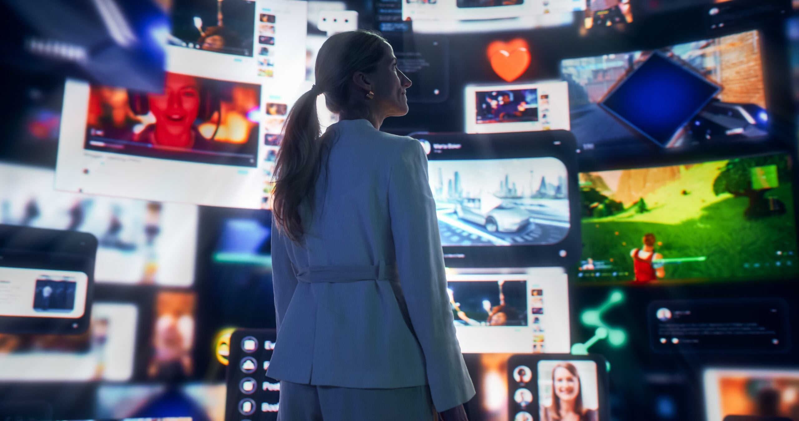 Women looking at a wall filled with social media screens.