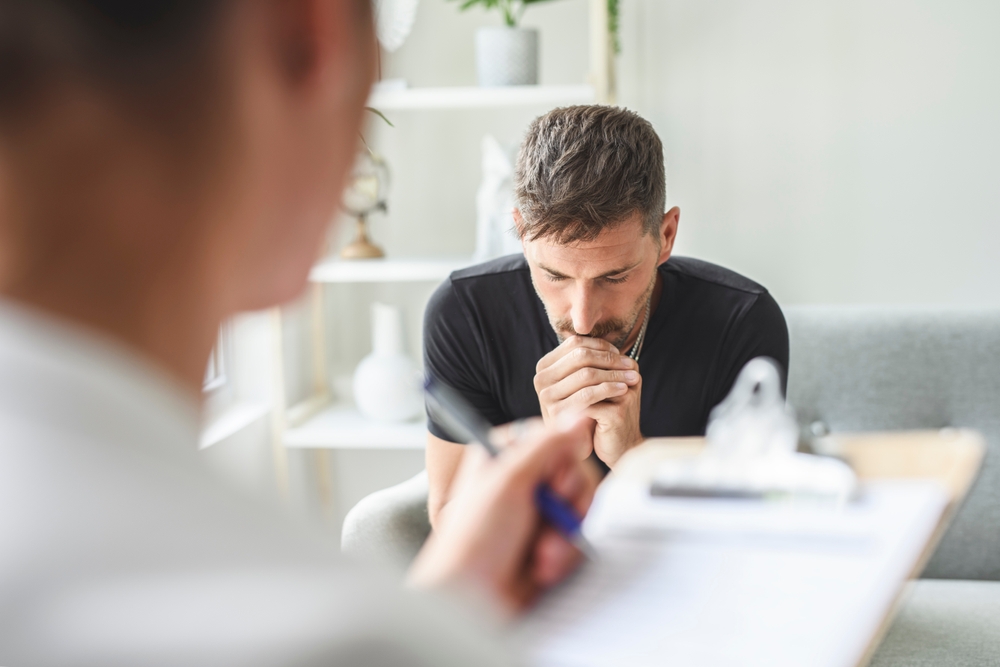 A depressed man during therapy with his psychologist