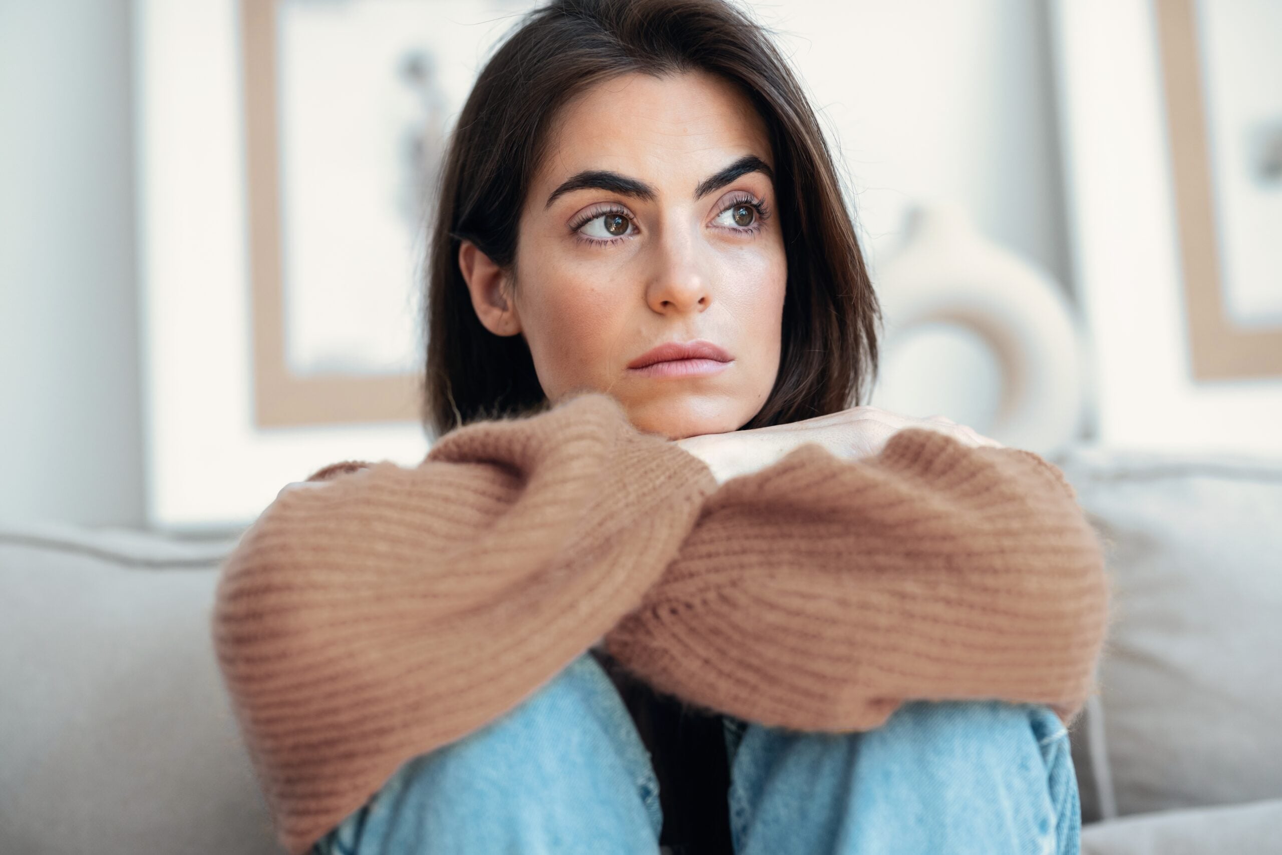 Woman feeling hollow on the inside sitting alone. 