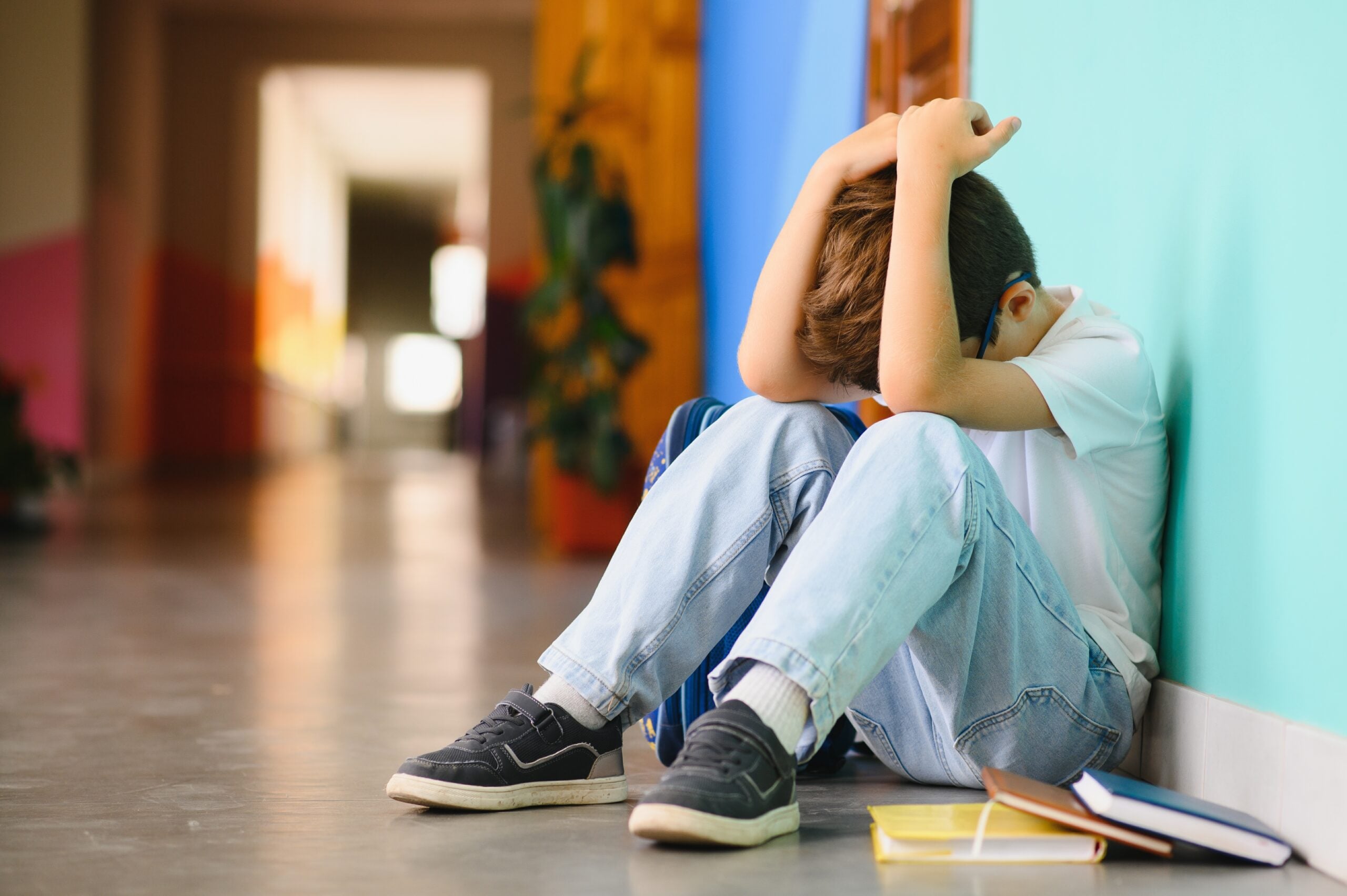 A little boy sitting alone and lonely after school.