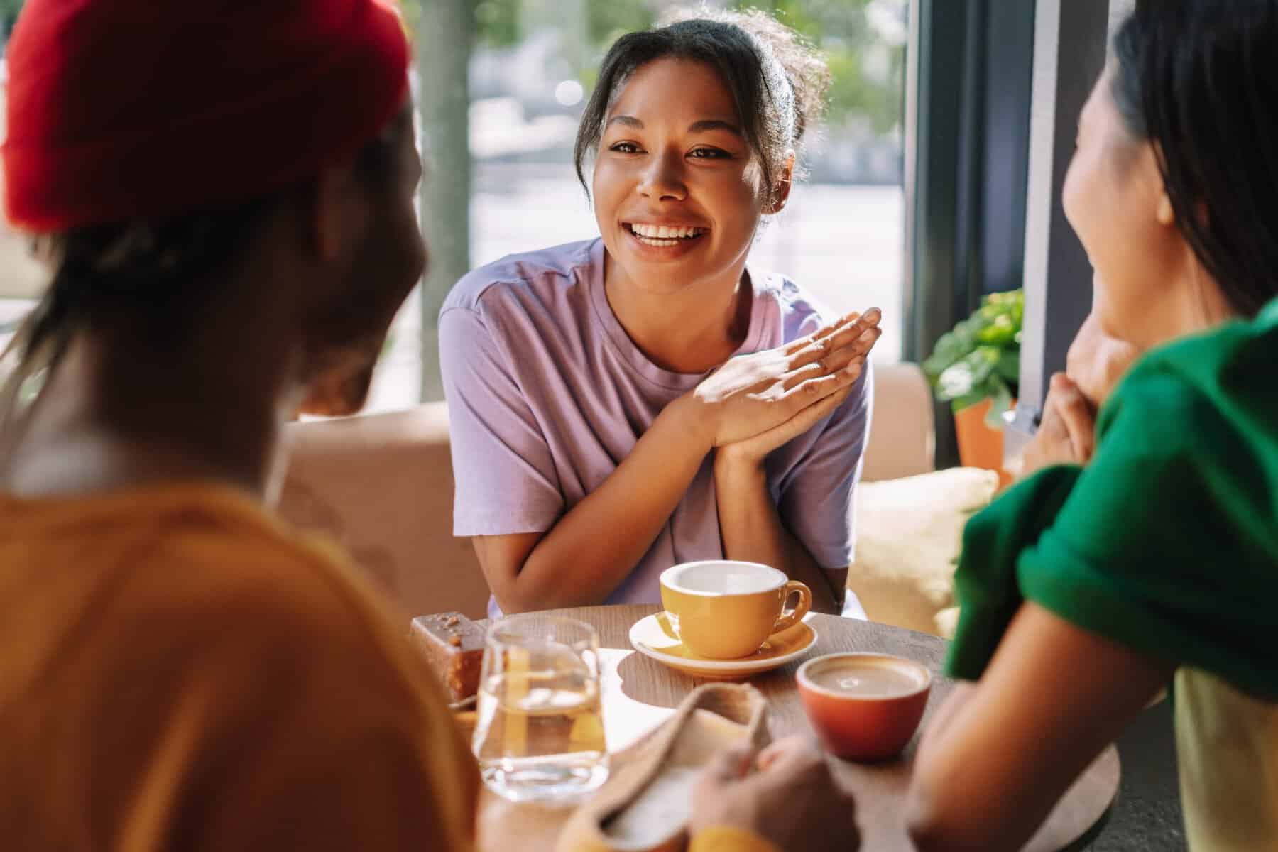 Three friends catching up together over coffee.