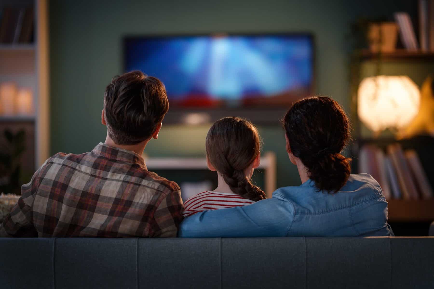 Average American family watching TV together.