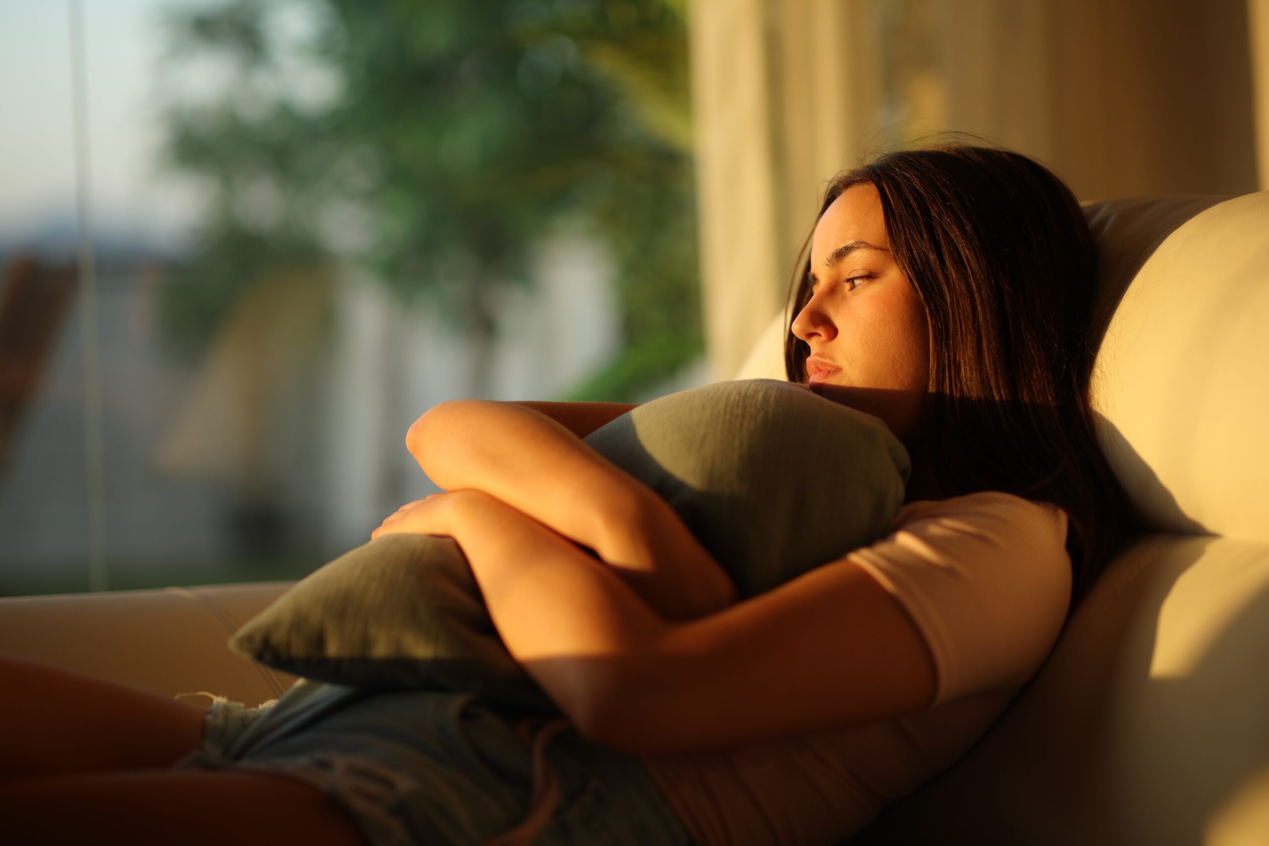 A lonely woman sitting alone and replaying conversations in her head.