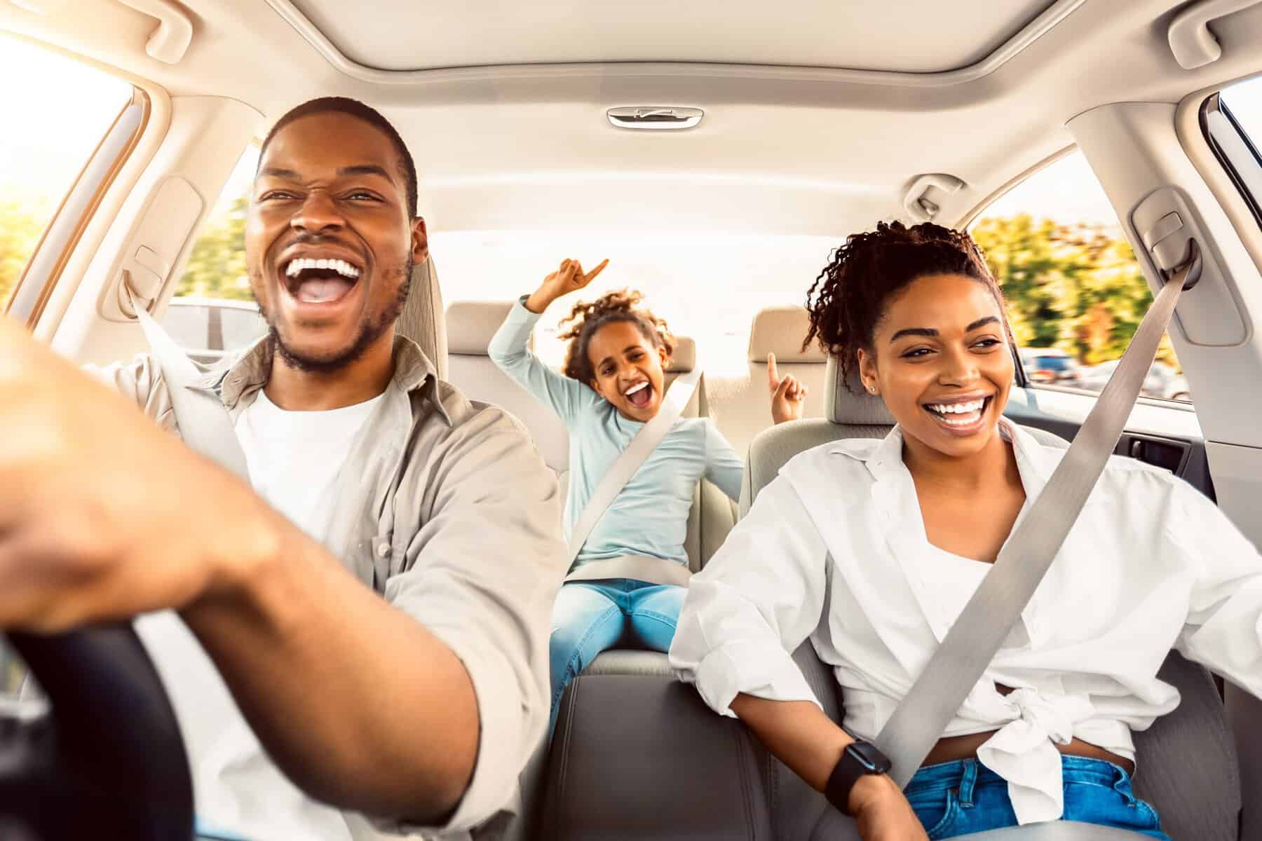 A family enjoying the car ride on their road trip.
