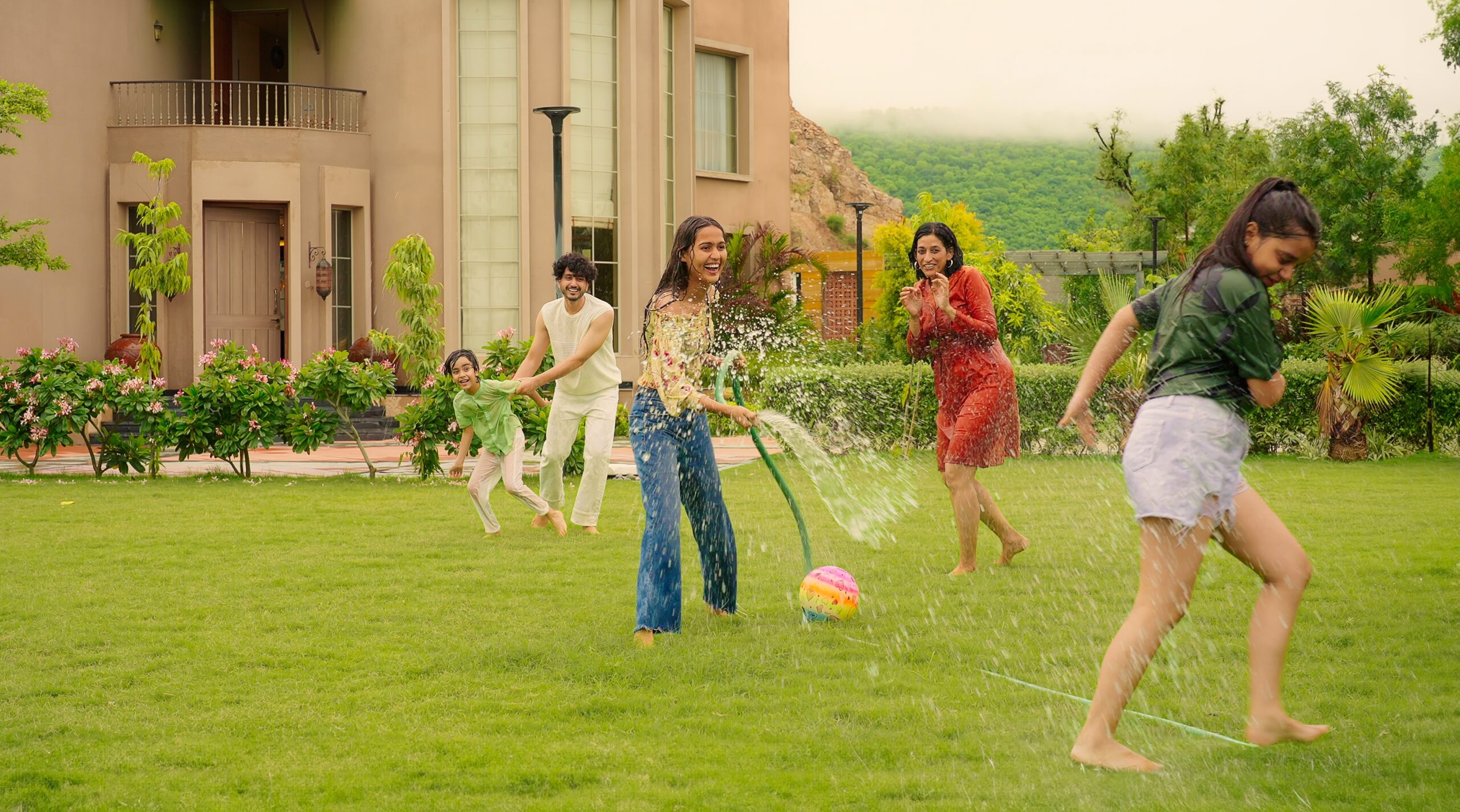 A happy extended family having outdoor fun at their home.