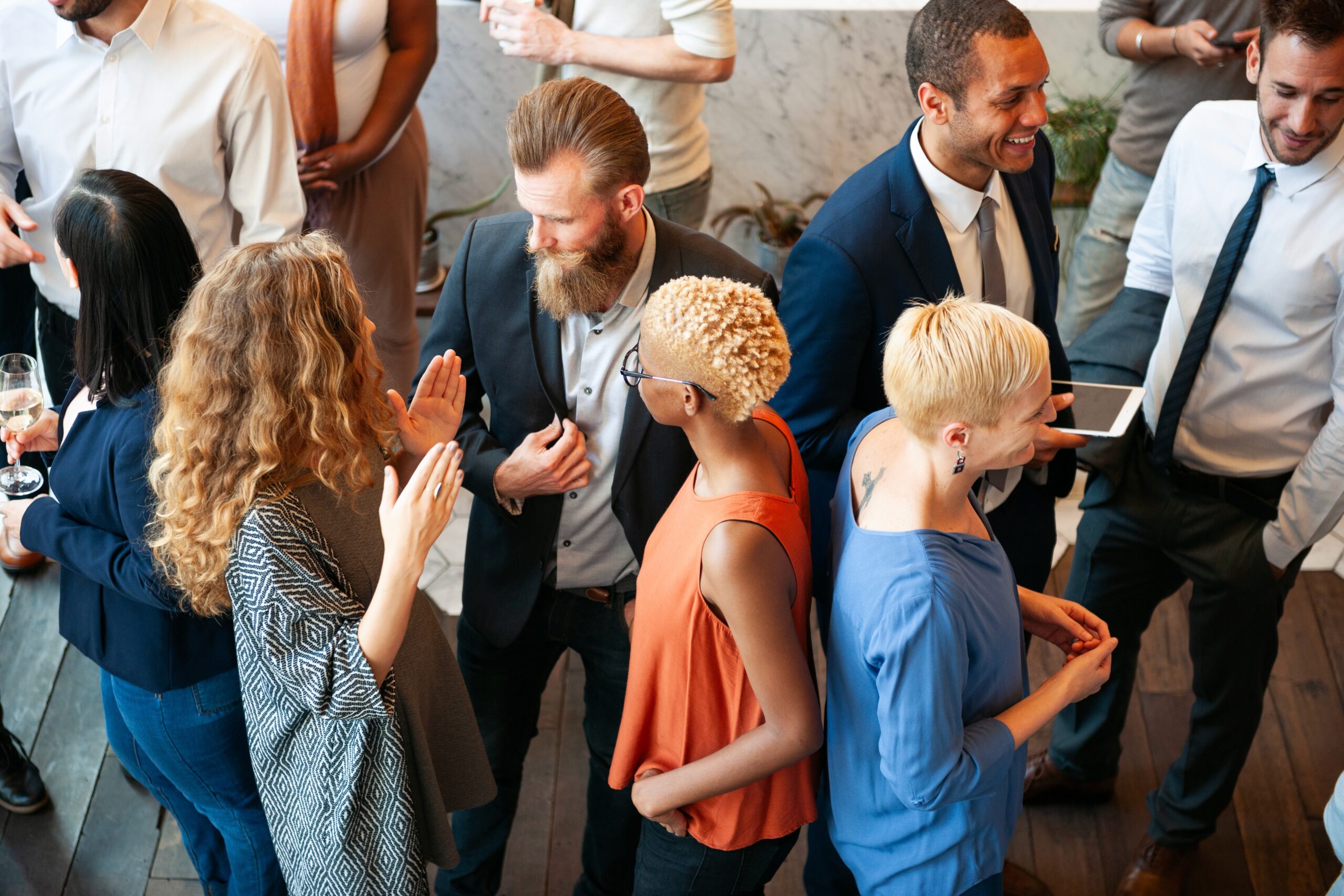 A woman being asked questions by a man at a networking event.