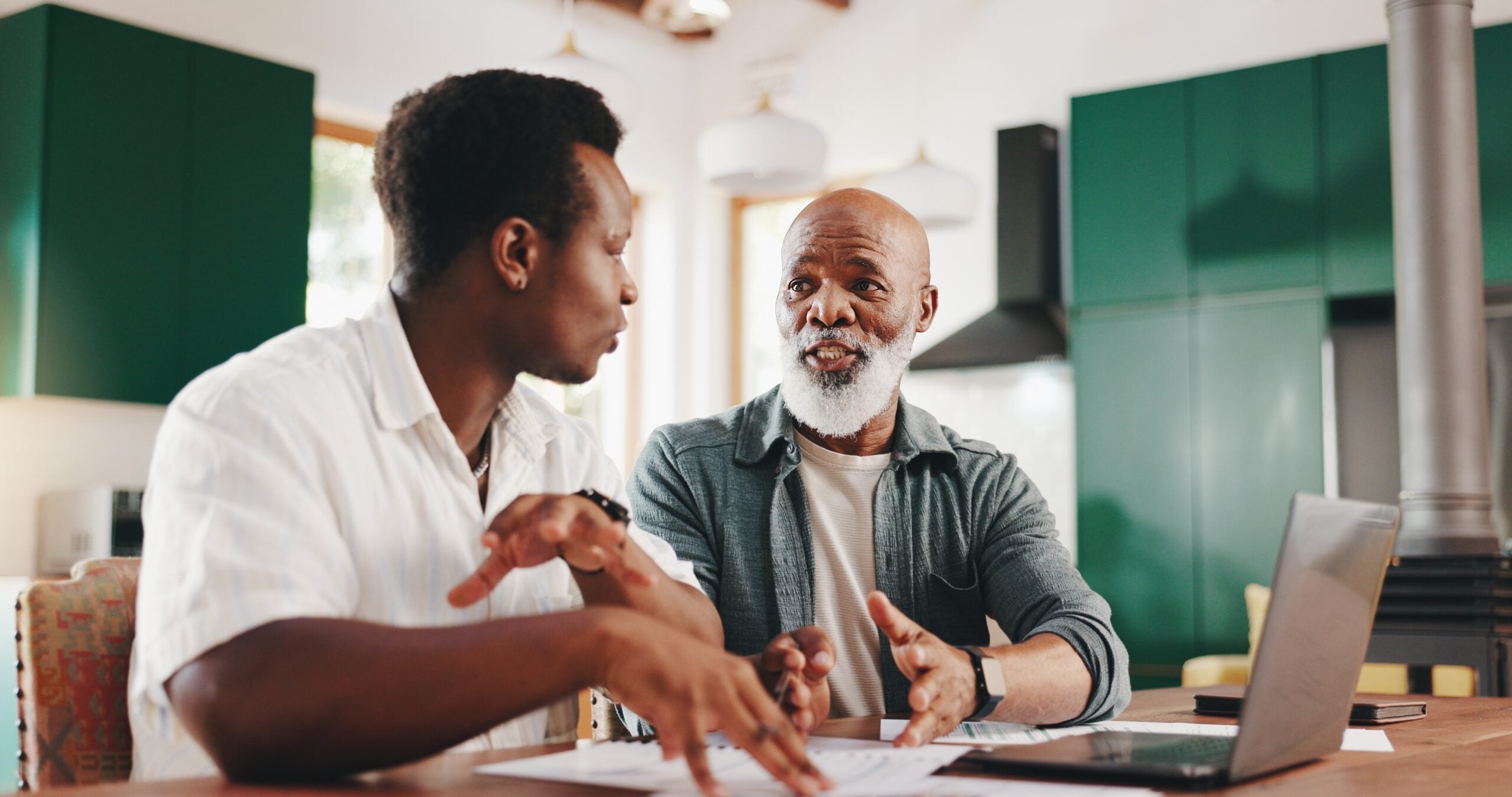 A father having a frank discussion with his adult son about paying bills.