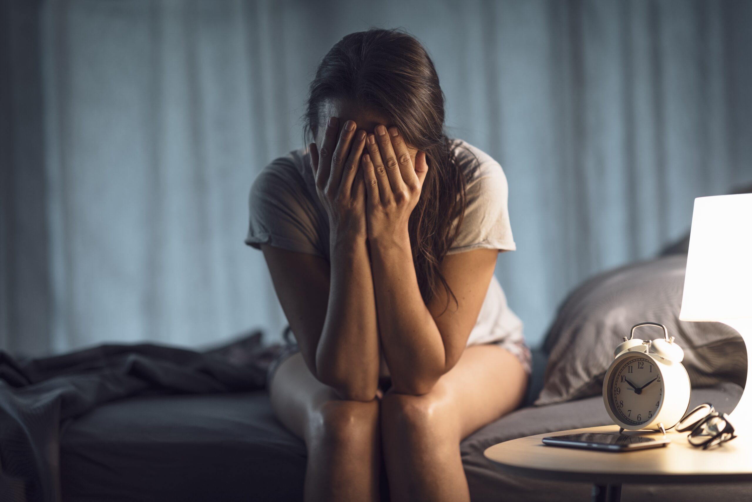 A woman awake in the middle of the night unable to sleep.