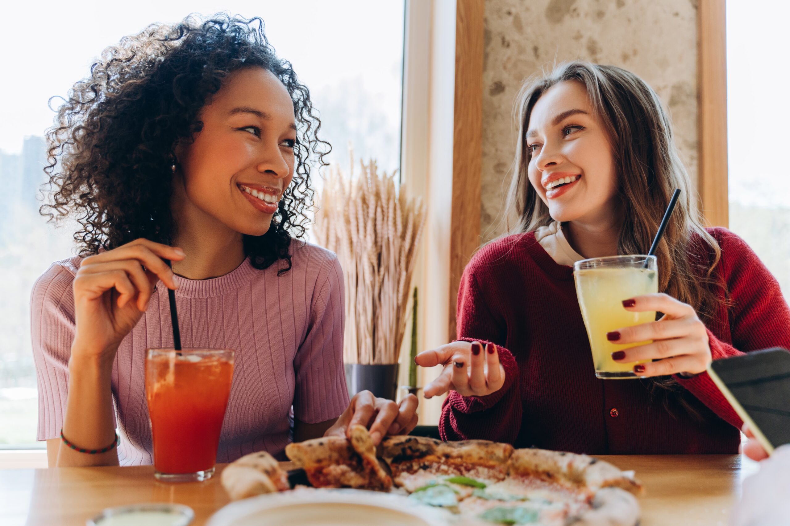 Two women deep in conversation over lunch.