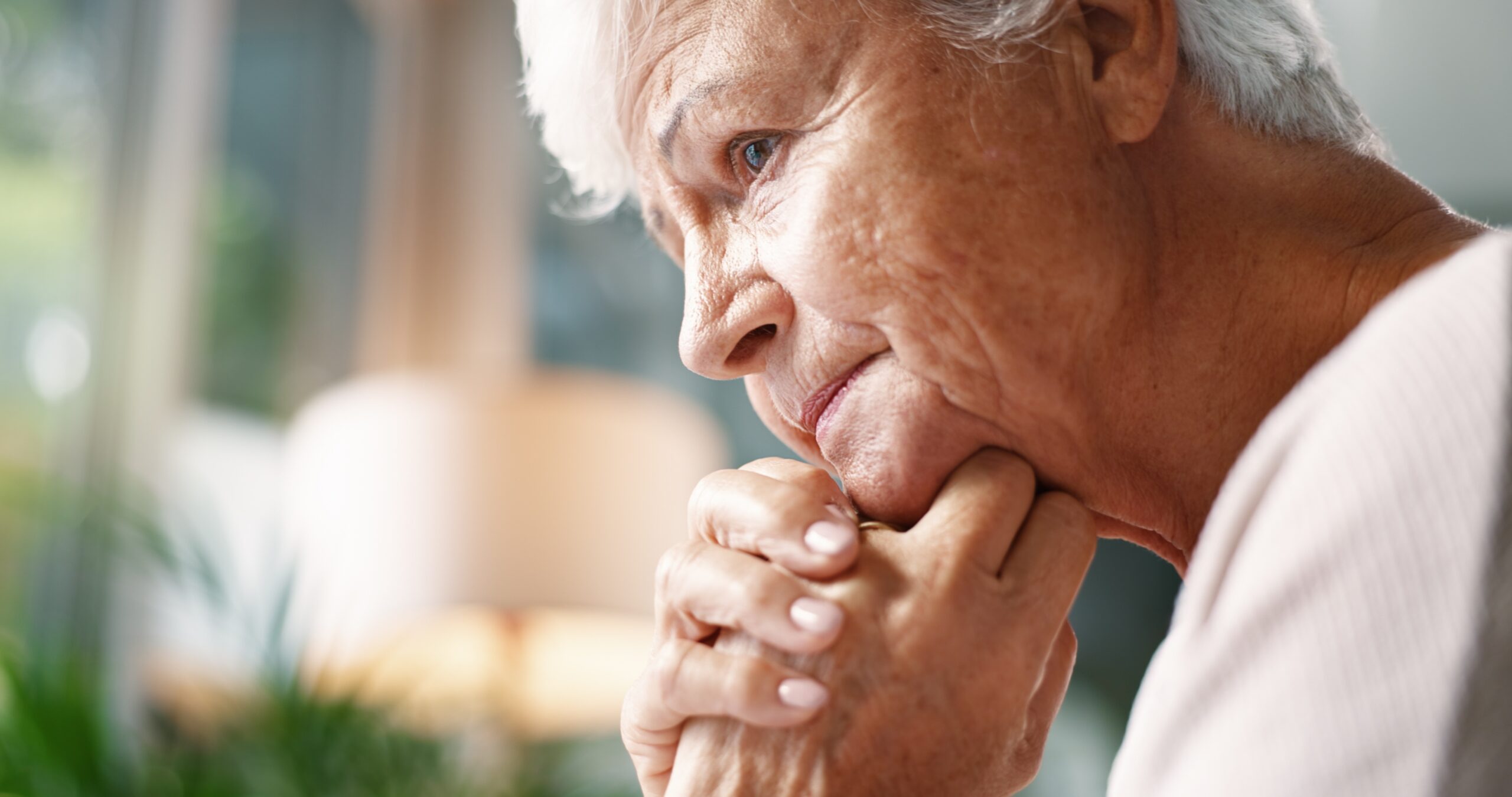 A mature woman thinking about something painful.
