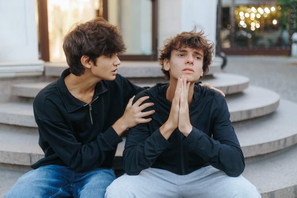 Two teenage friends consoling each other