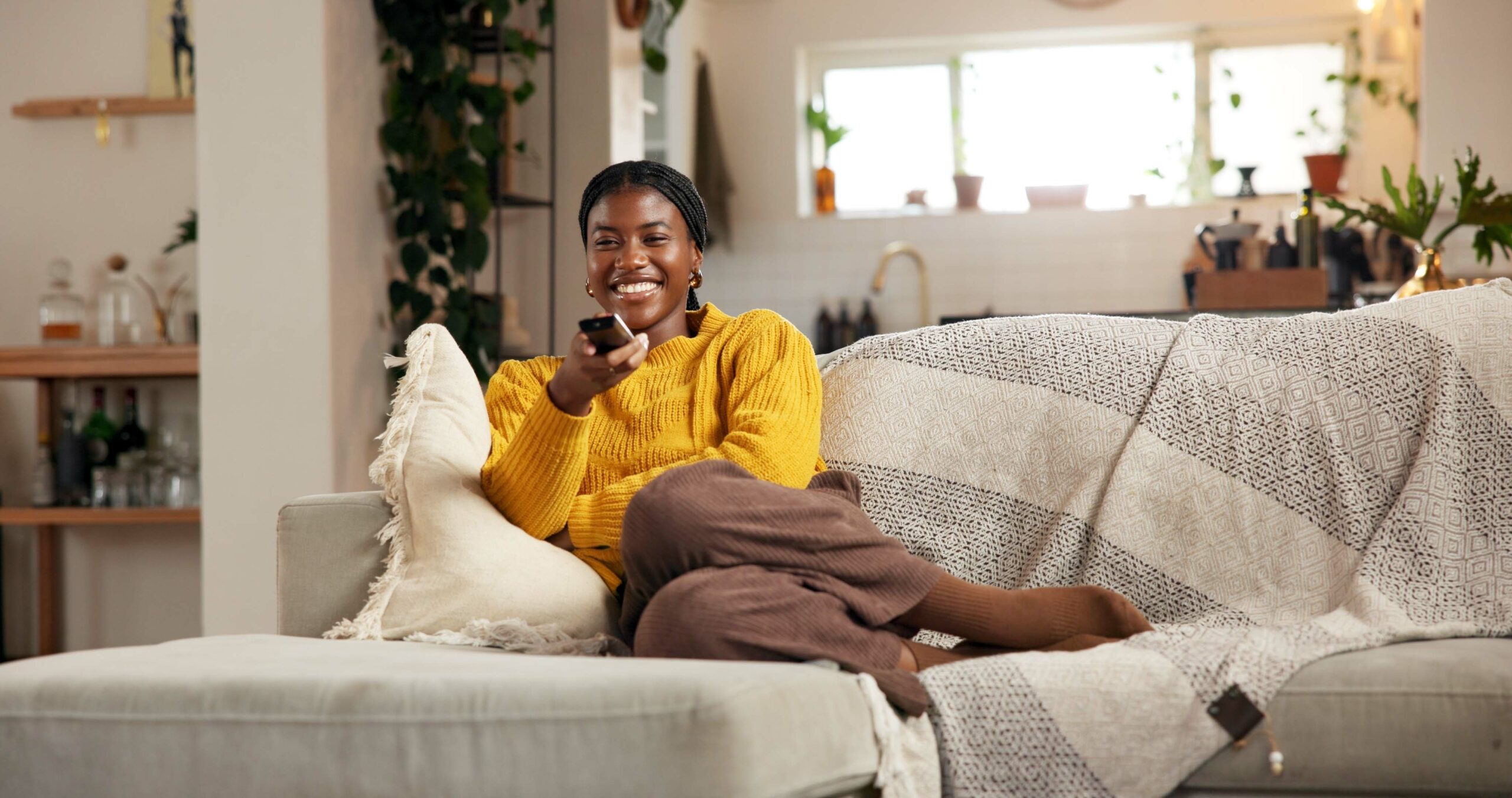 A woman choosing a documentary to watch on TV.