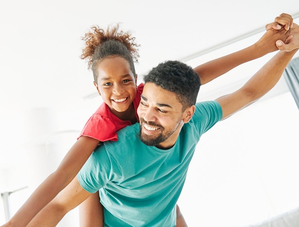 A father and his daughter having fun together at home.