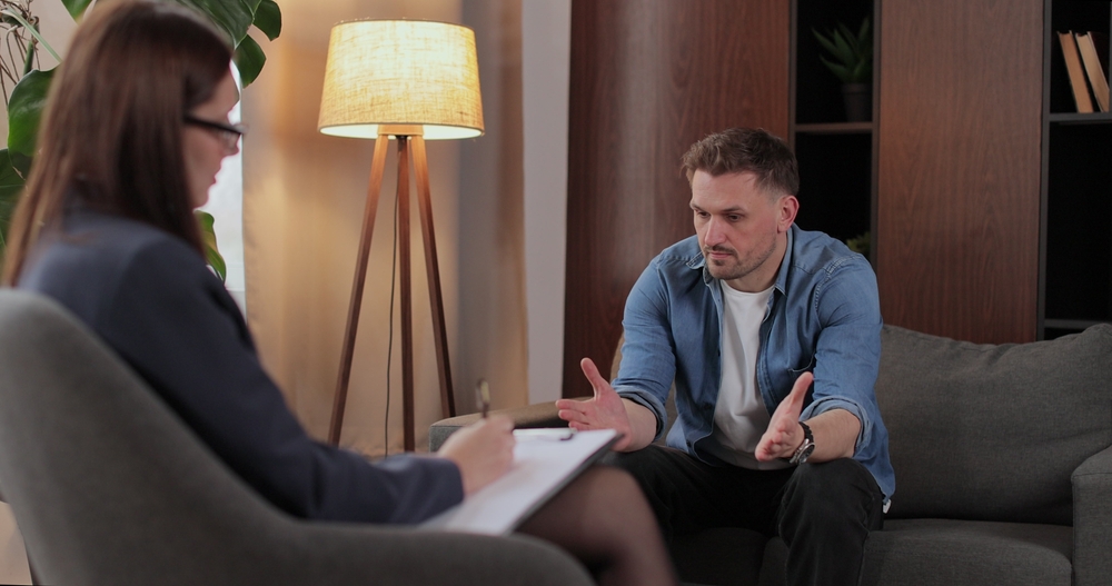 A man talking to his therapist during his therapy session