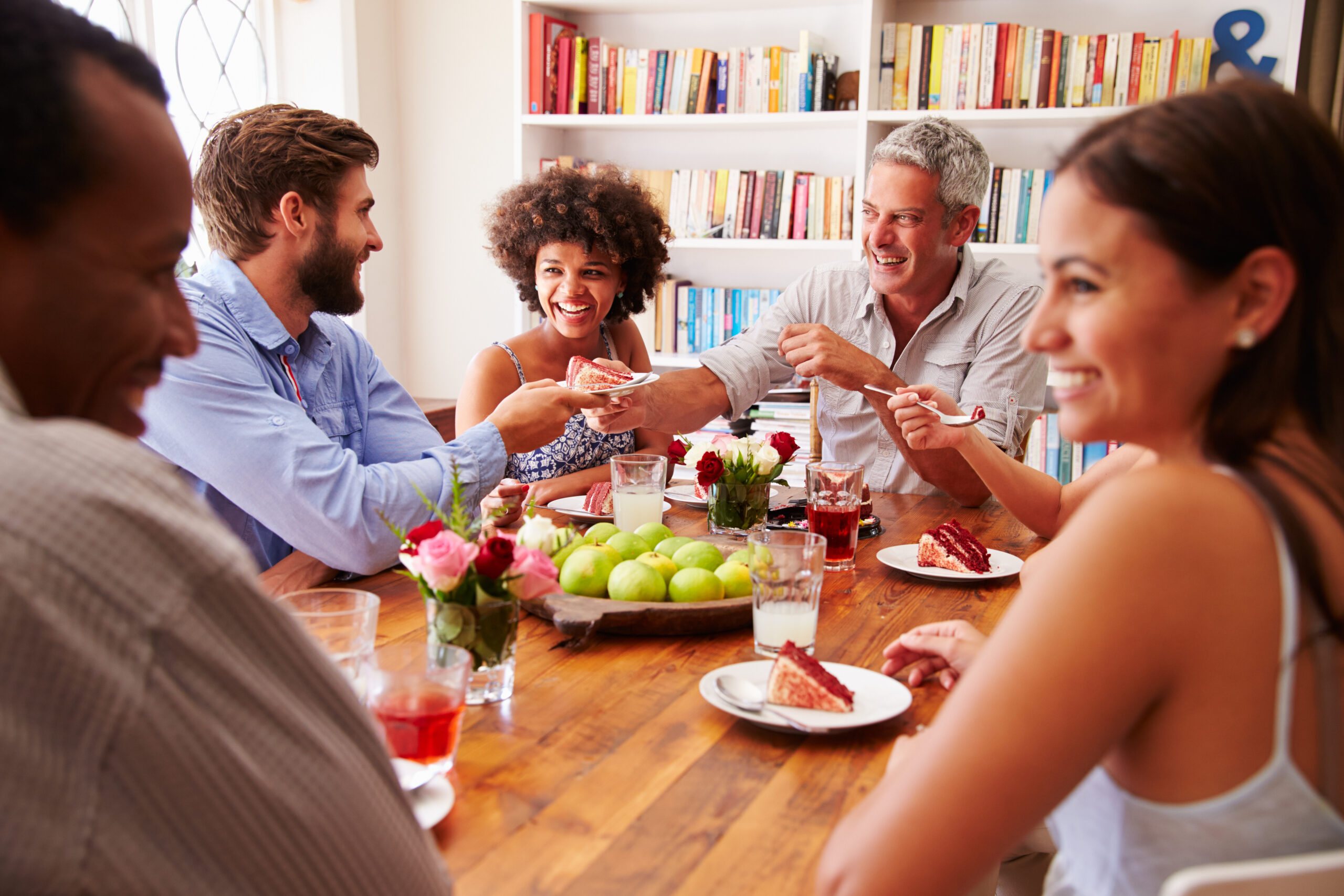 A group of friends talking together at a dinner party.