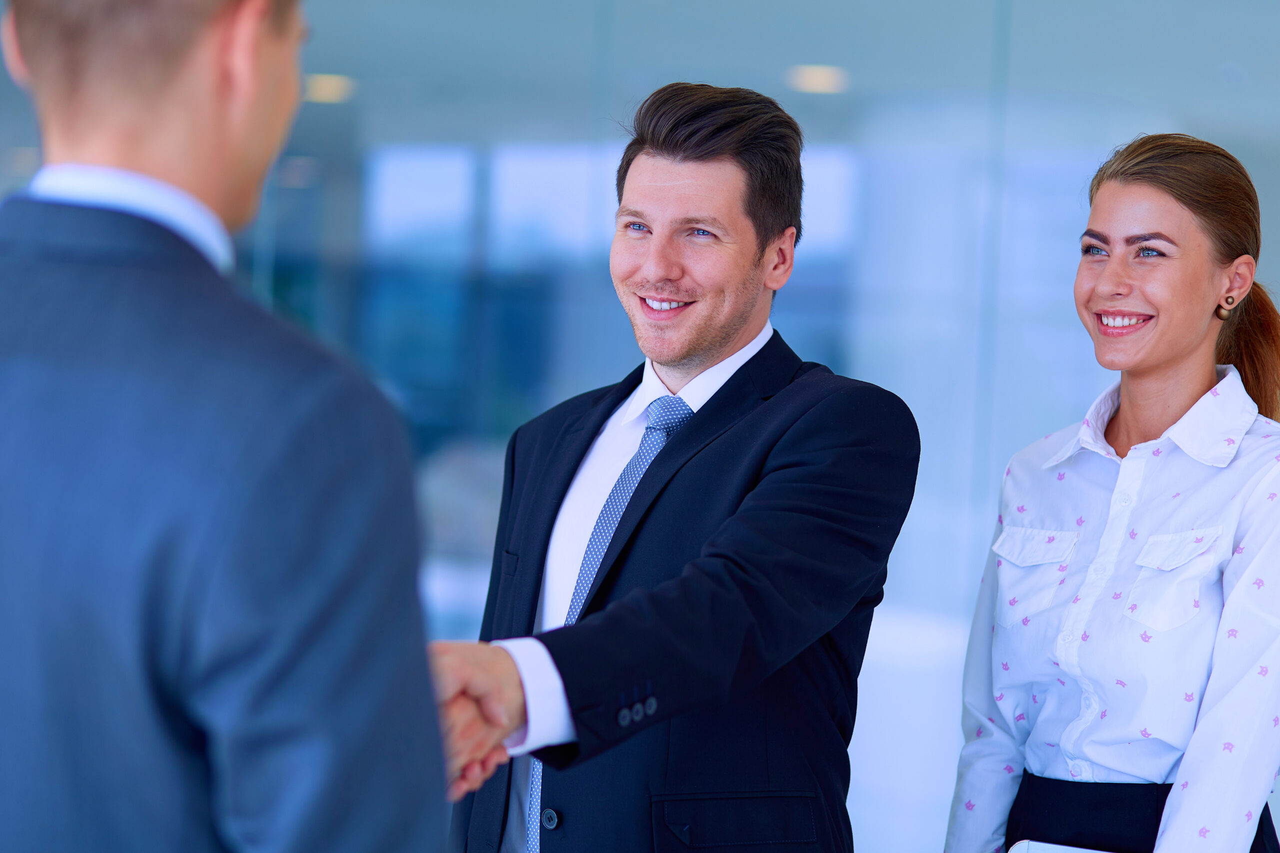 A man is congratulated over a promotion at work.