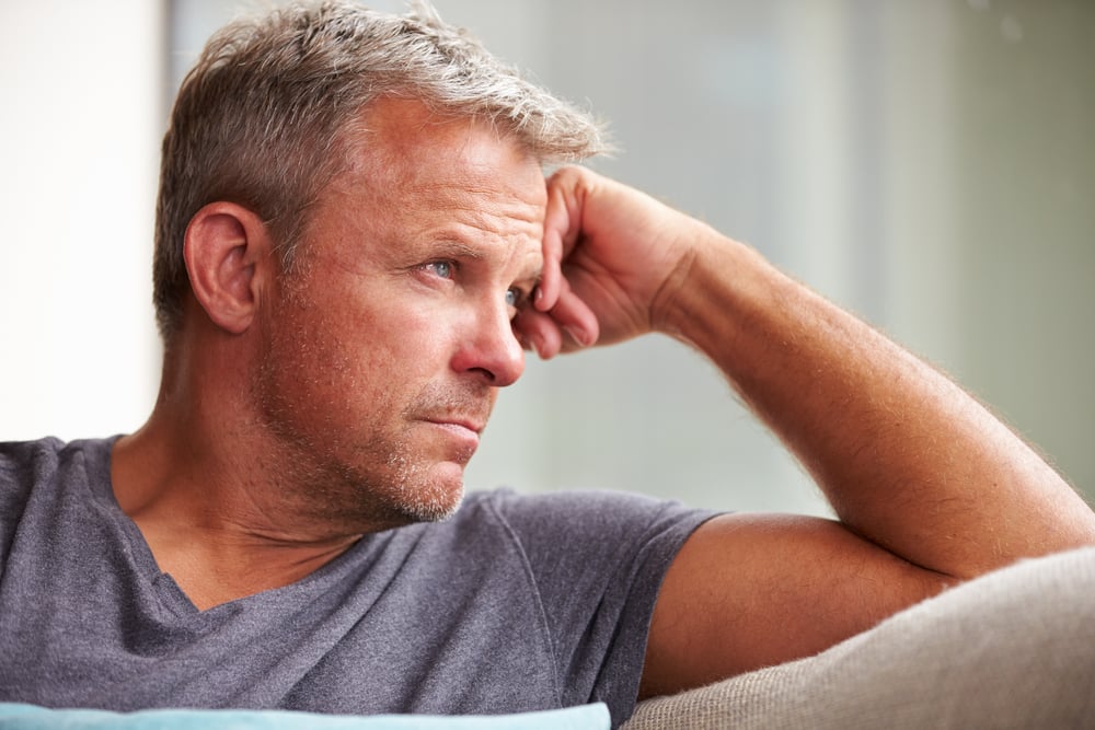 A grieving man alone at home. 