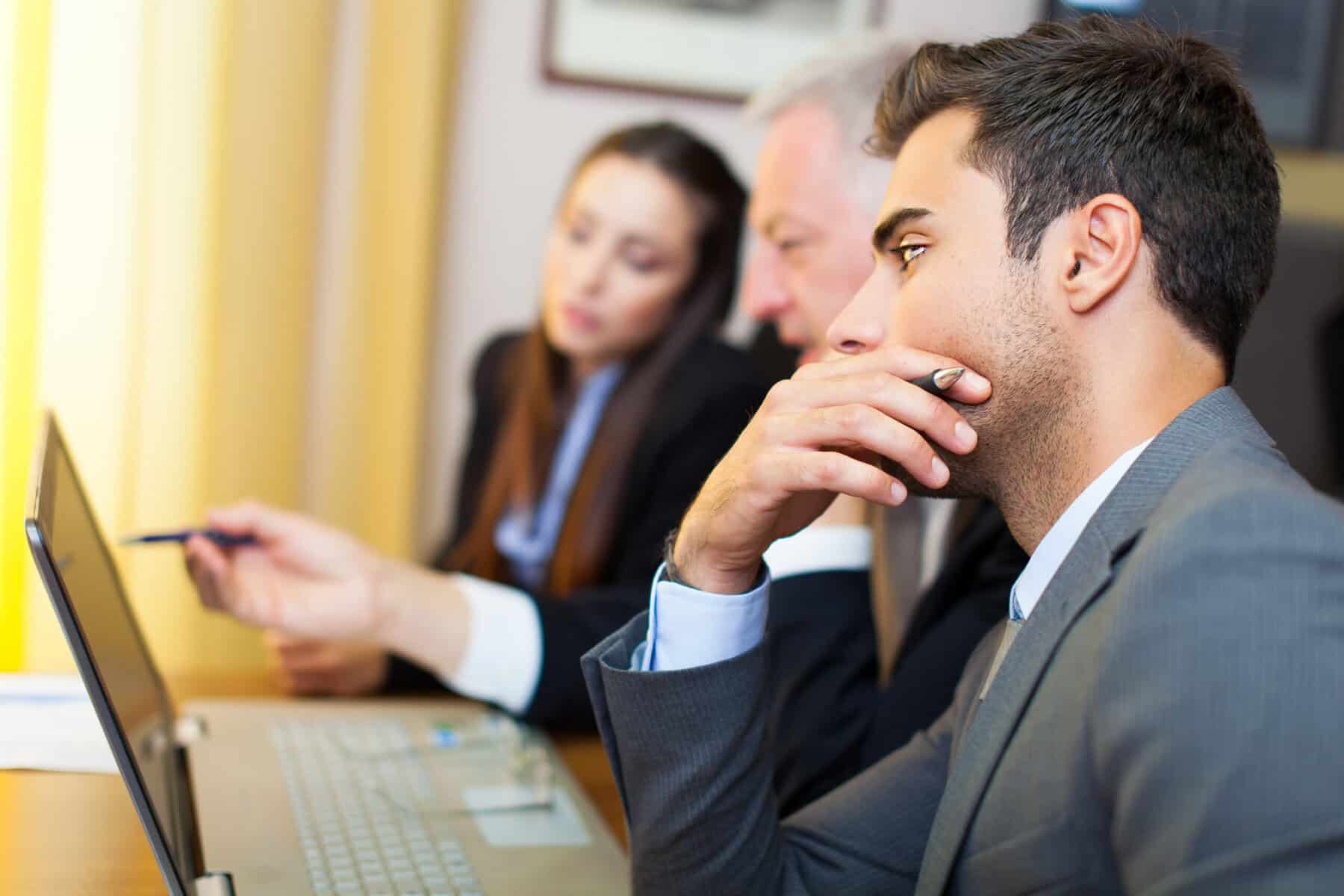 A team of business leaders thinking about next steps in a meeting.