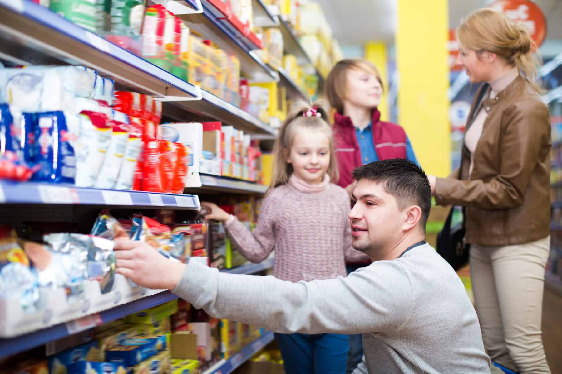A working class family of four purchasing groceries.