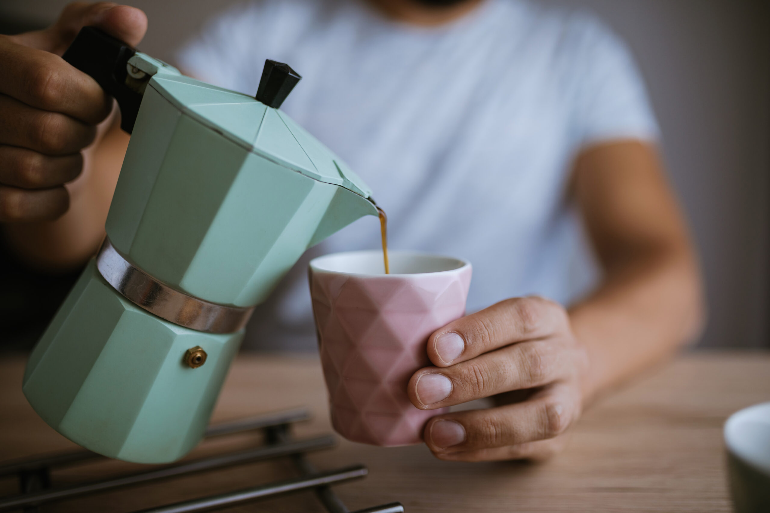 A man preparing his morning coffee.