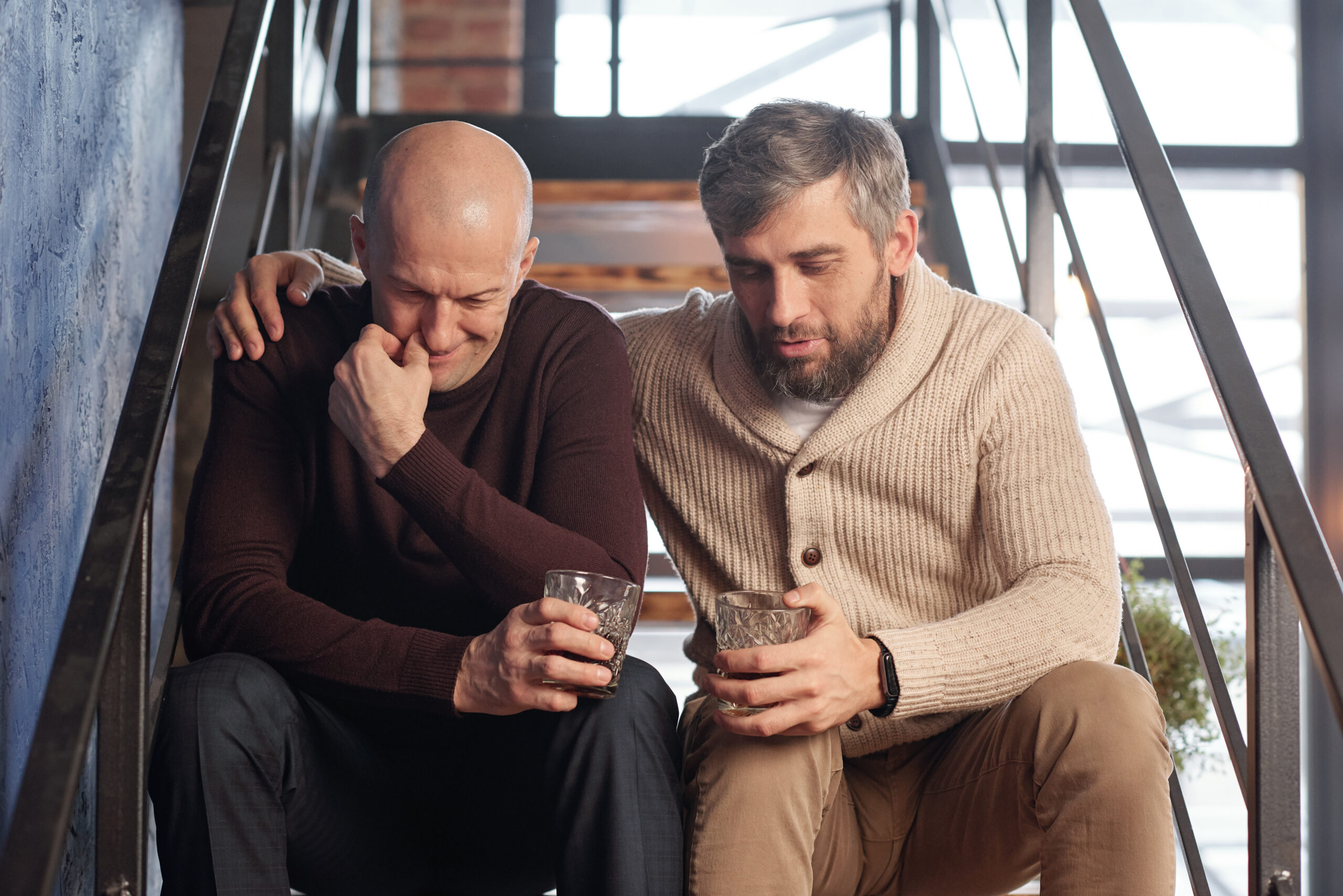 A senior man with his adult son having a heart to heart.
