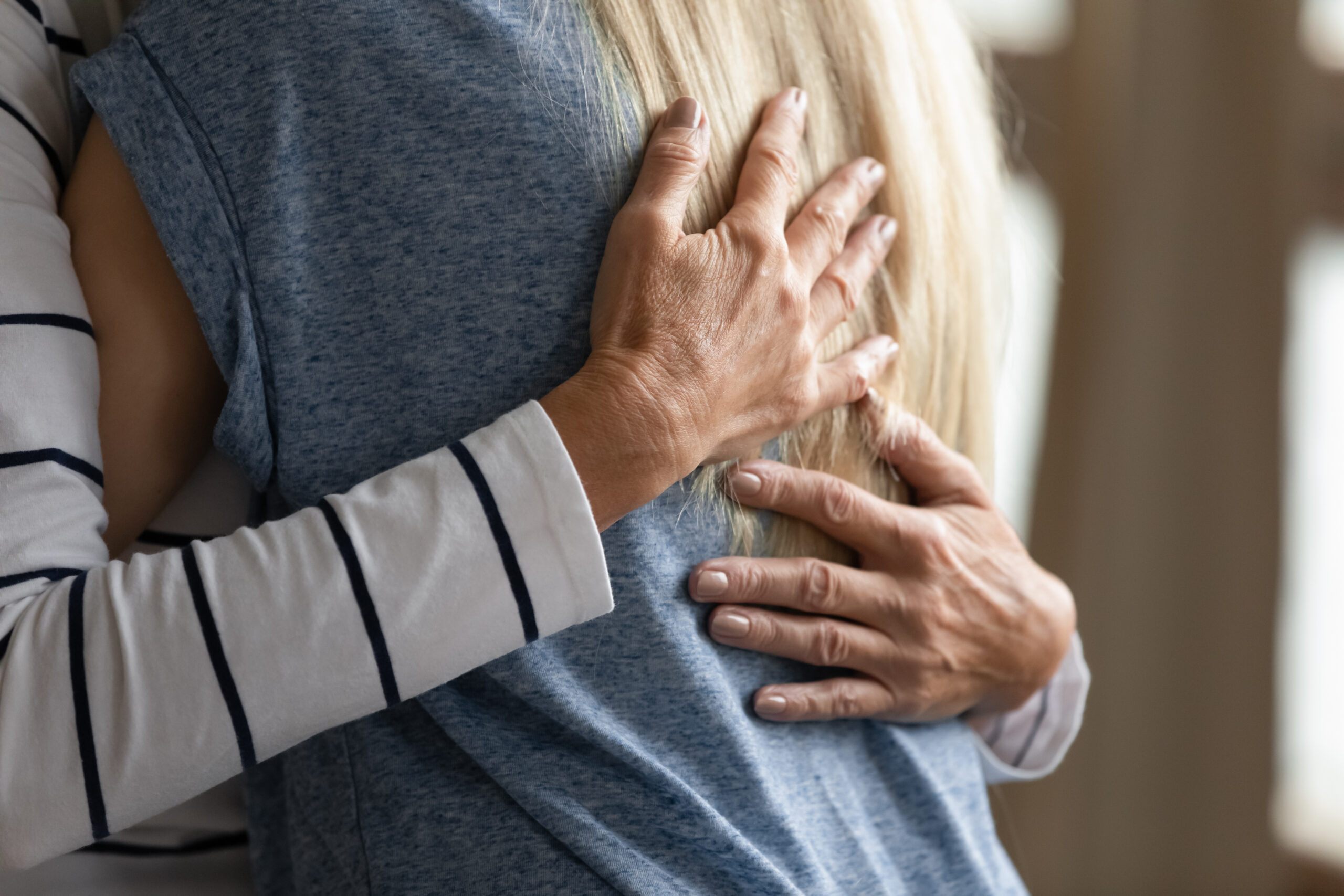 Two women in a safe embrace.