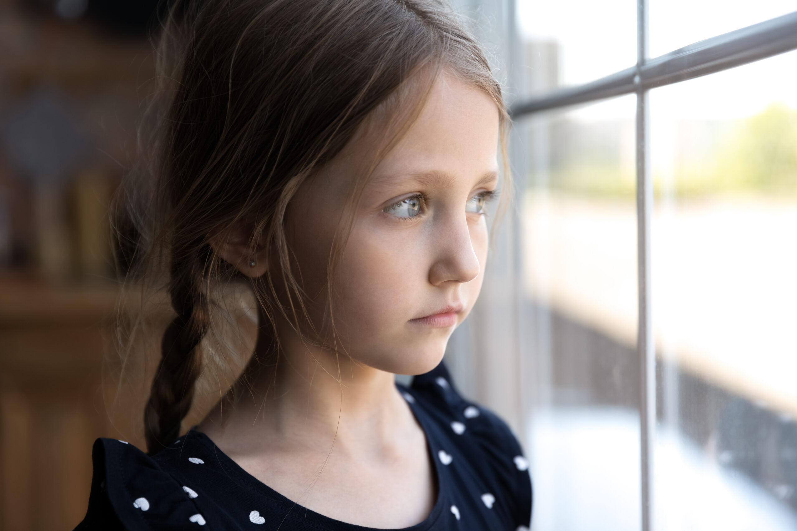 Little girl looking out the window.