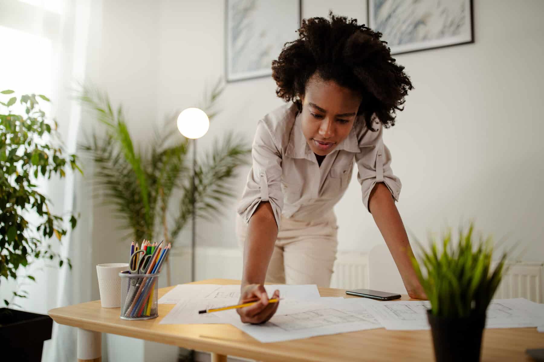 Woman working at a desk solving problems on her own.